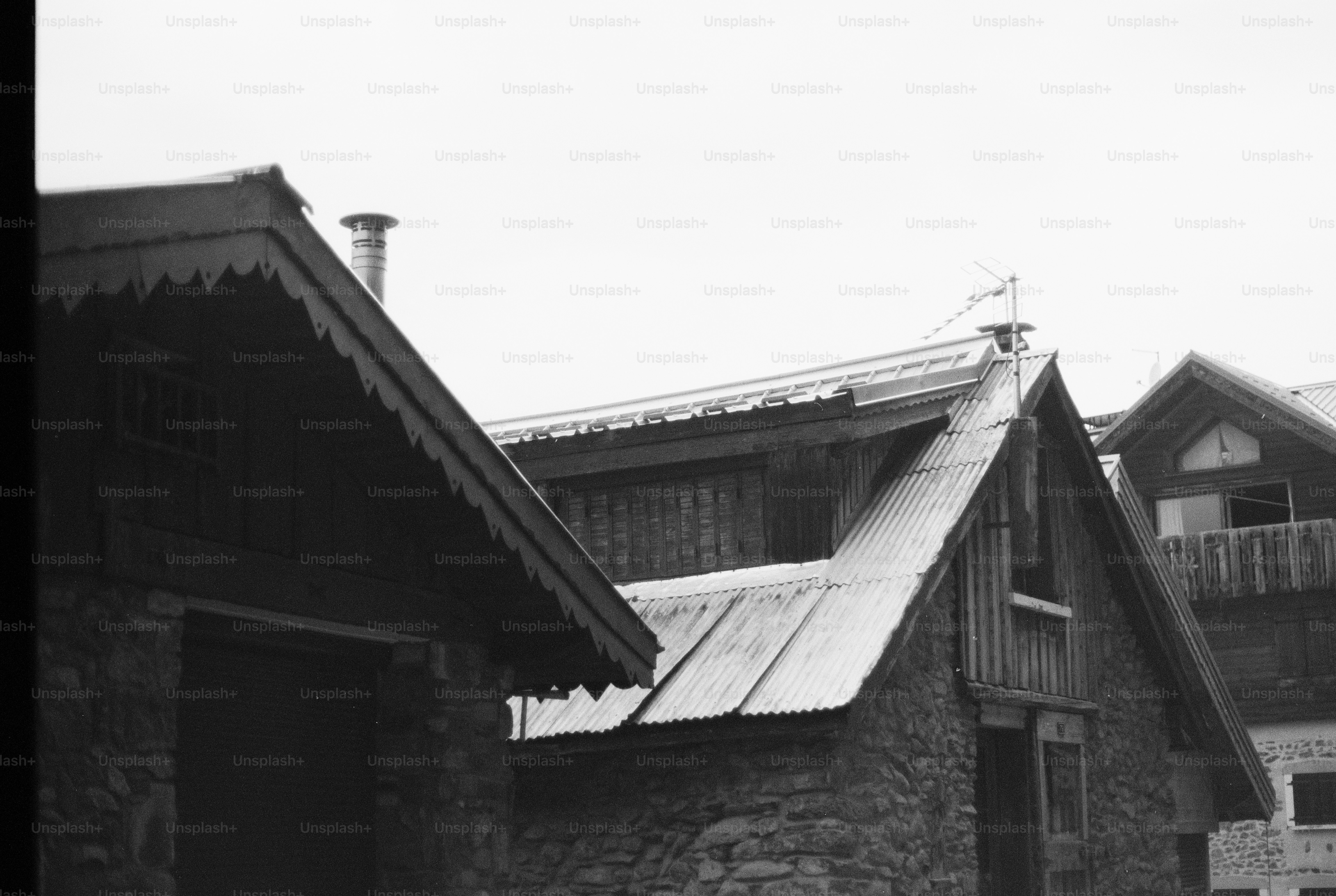 Black and white rustic gabled roofs and weather vane