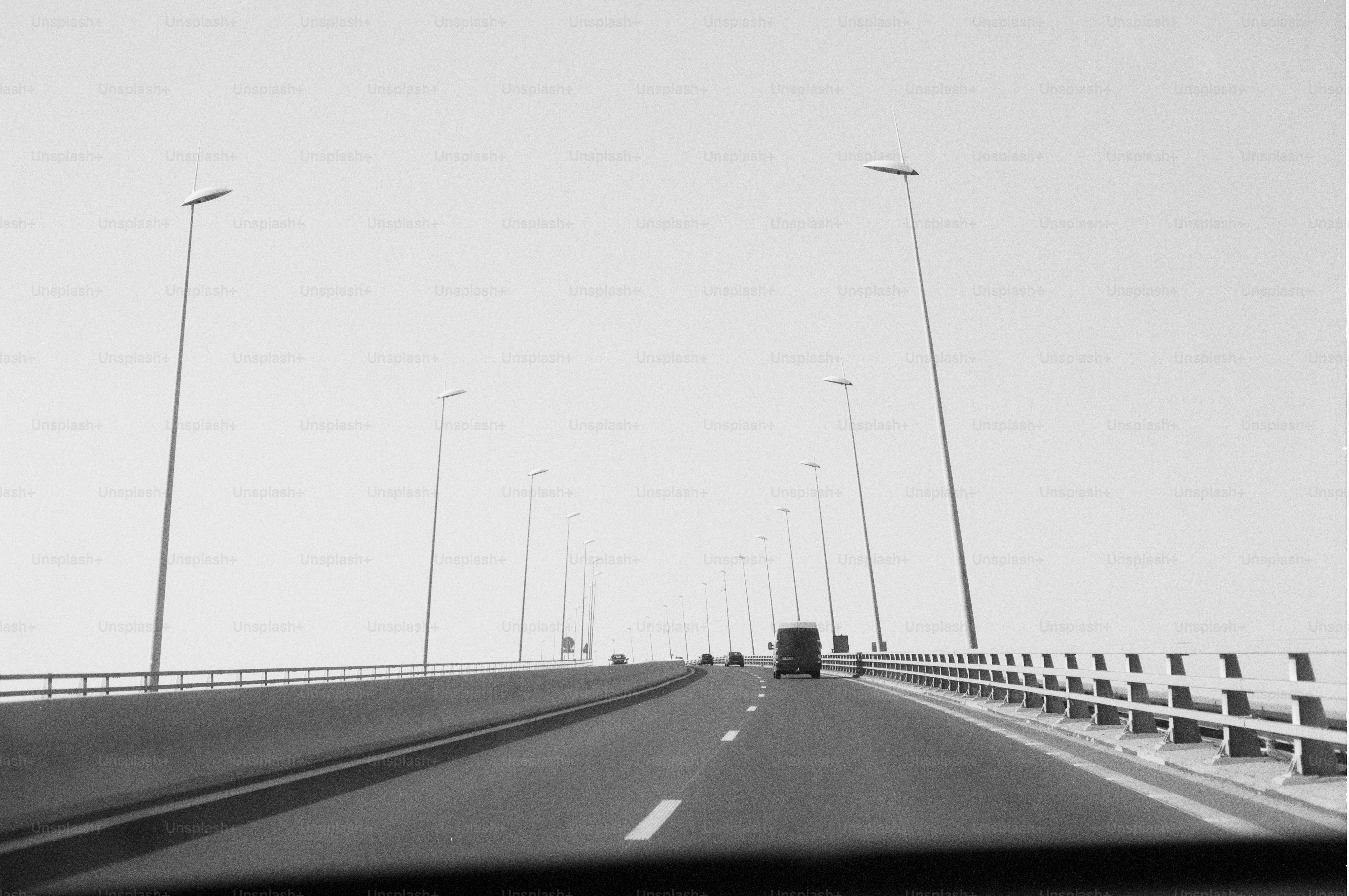 Long bridge with streetlights under an overcast sky