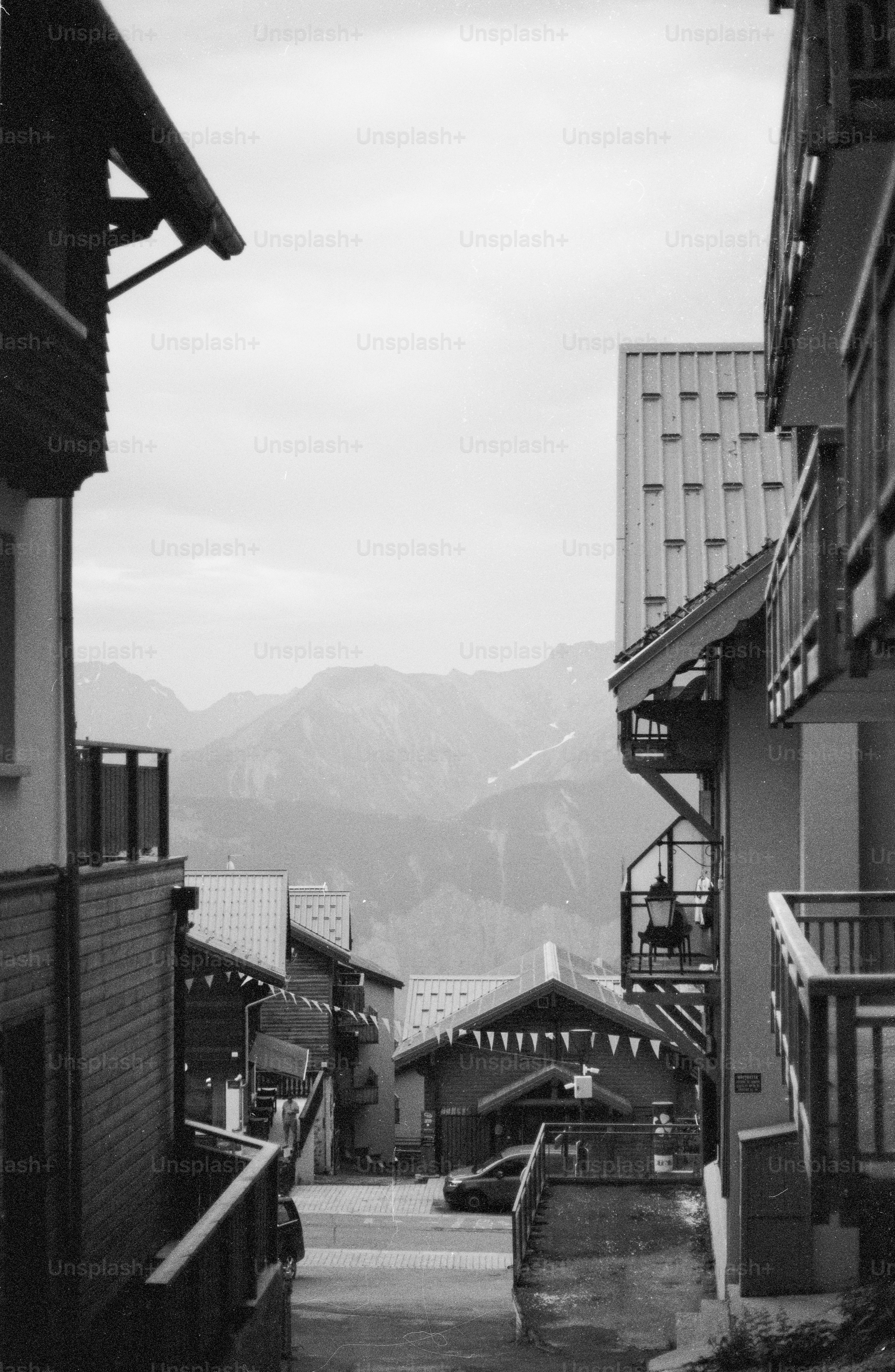Narrow street in an alpine village with mountains