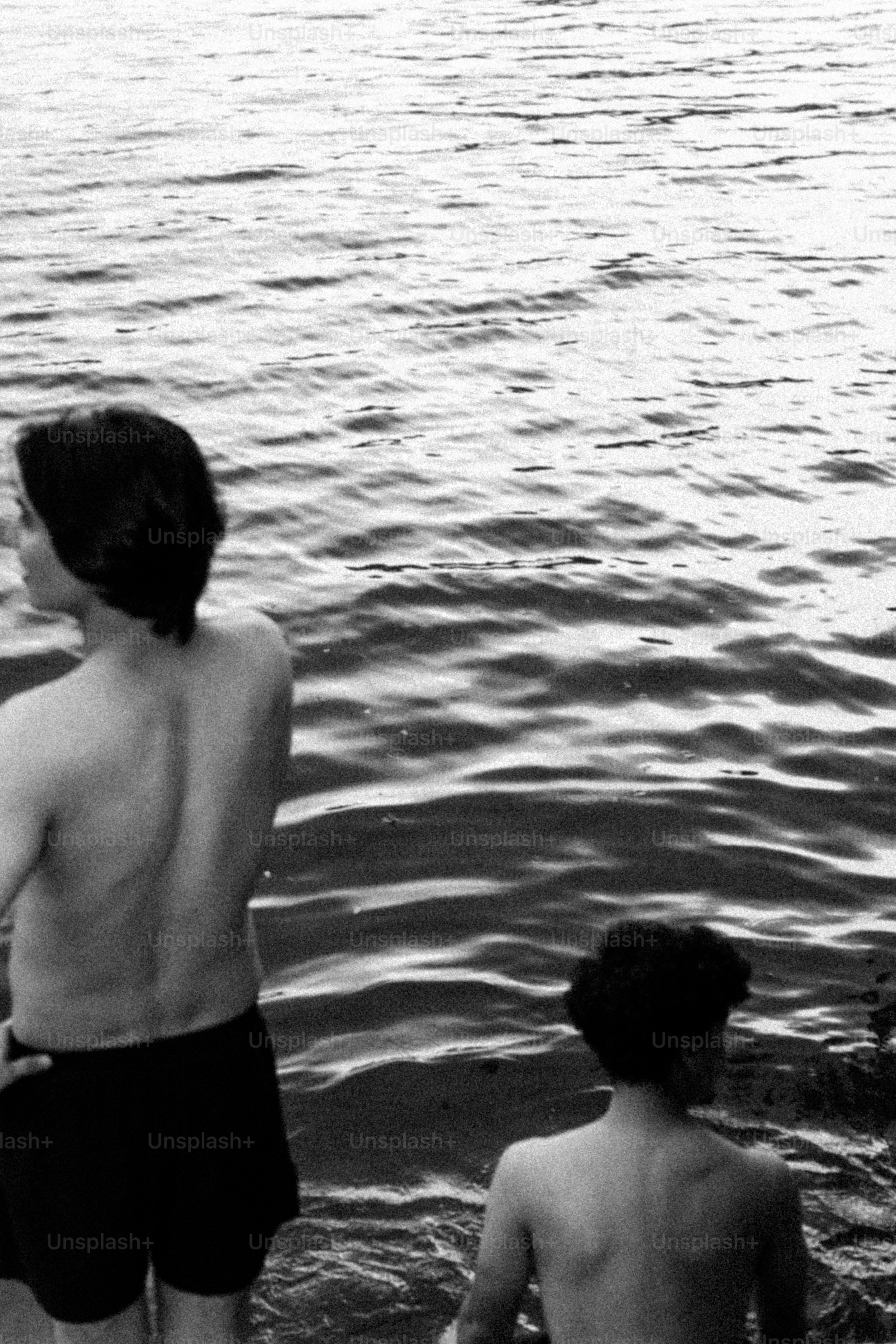 Two people wading in rippling water