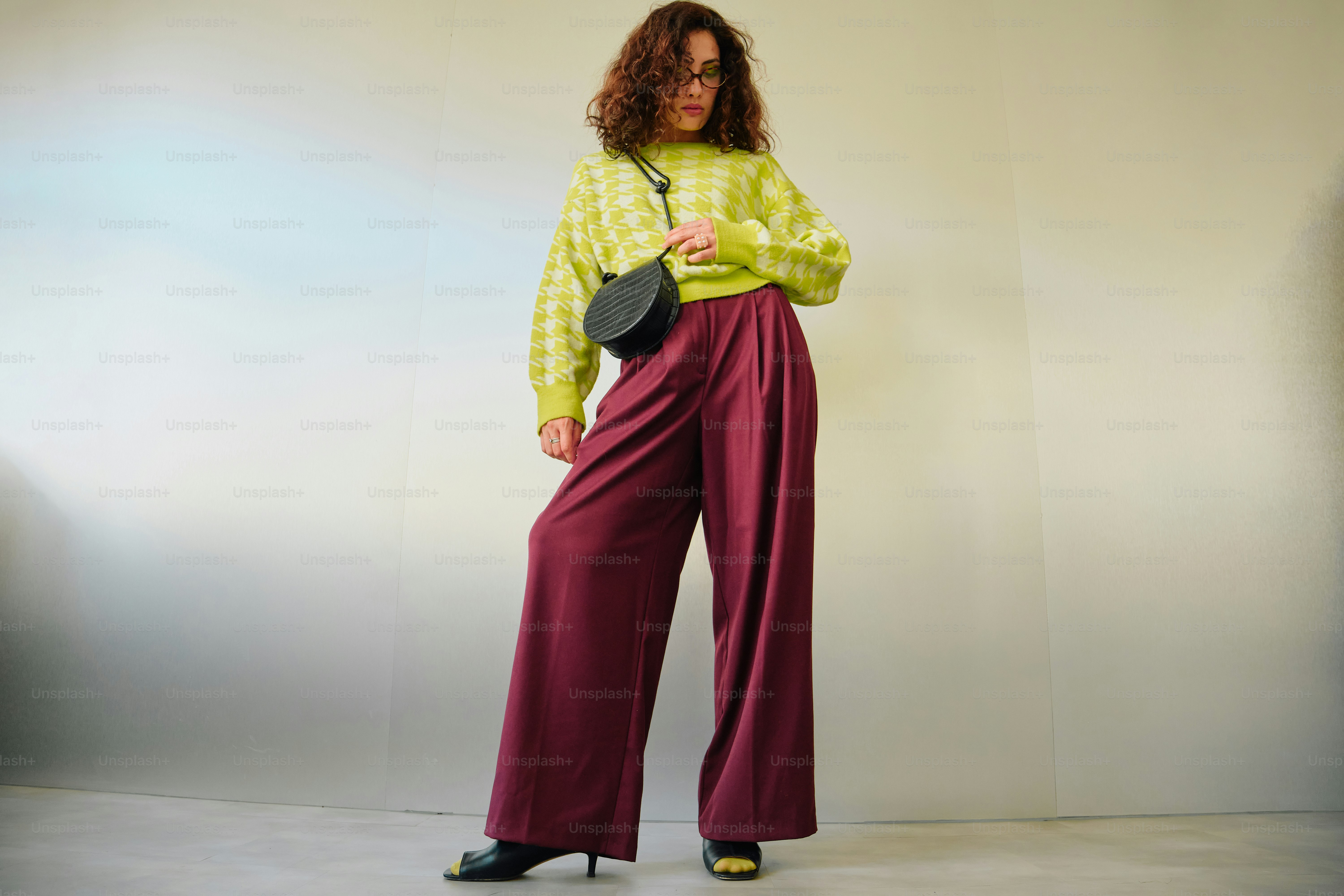 Woman wearing chartreuse sweater and burgundy pants