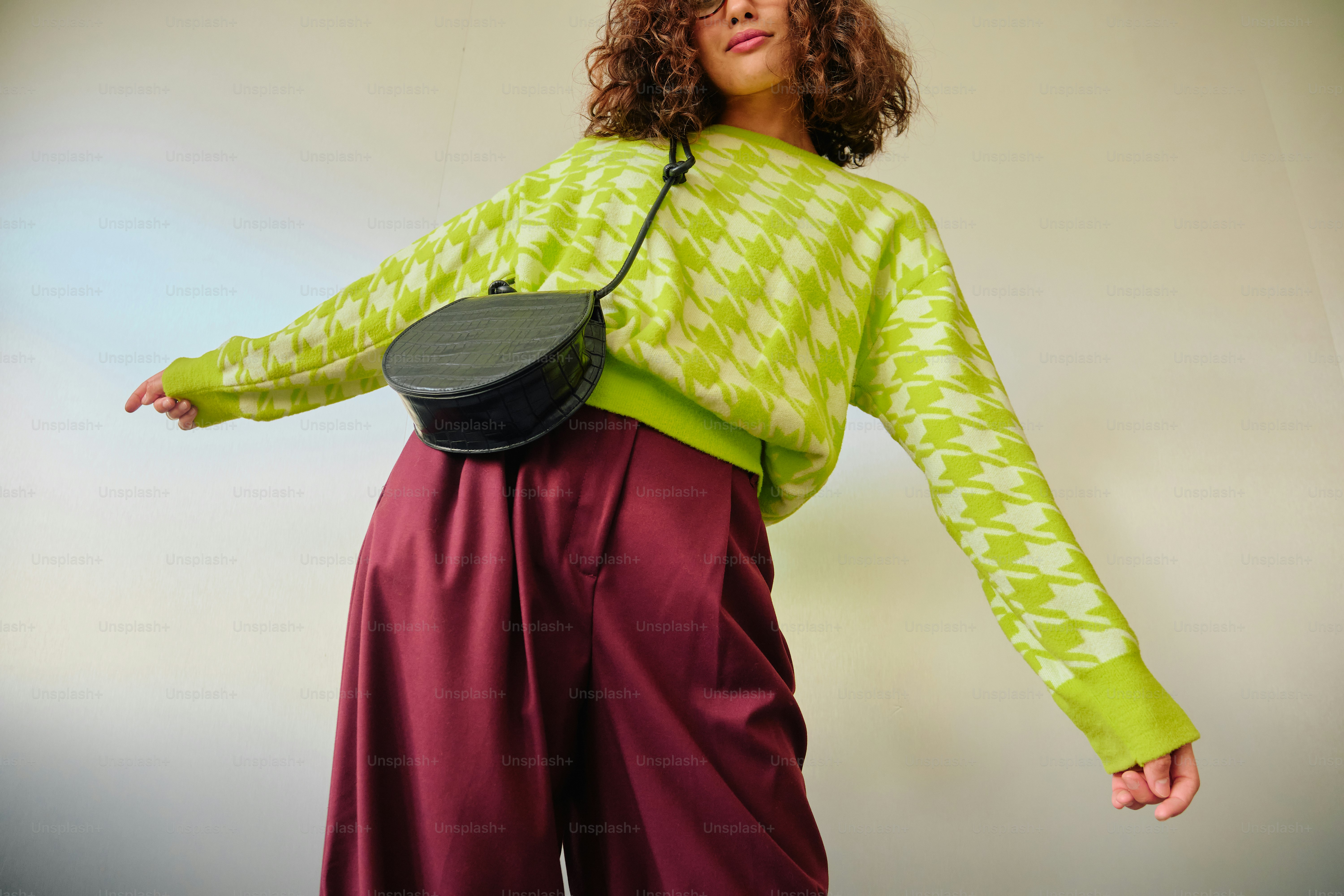 Woman in chartreuse patterned sweater and burgundy pants