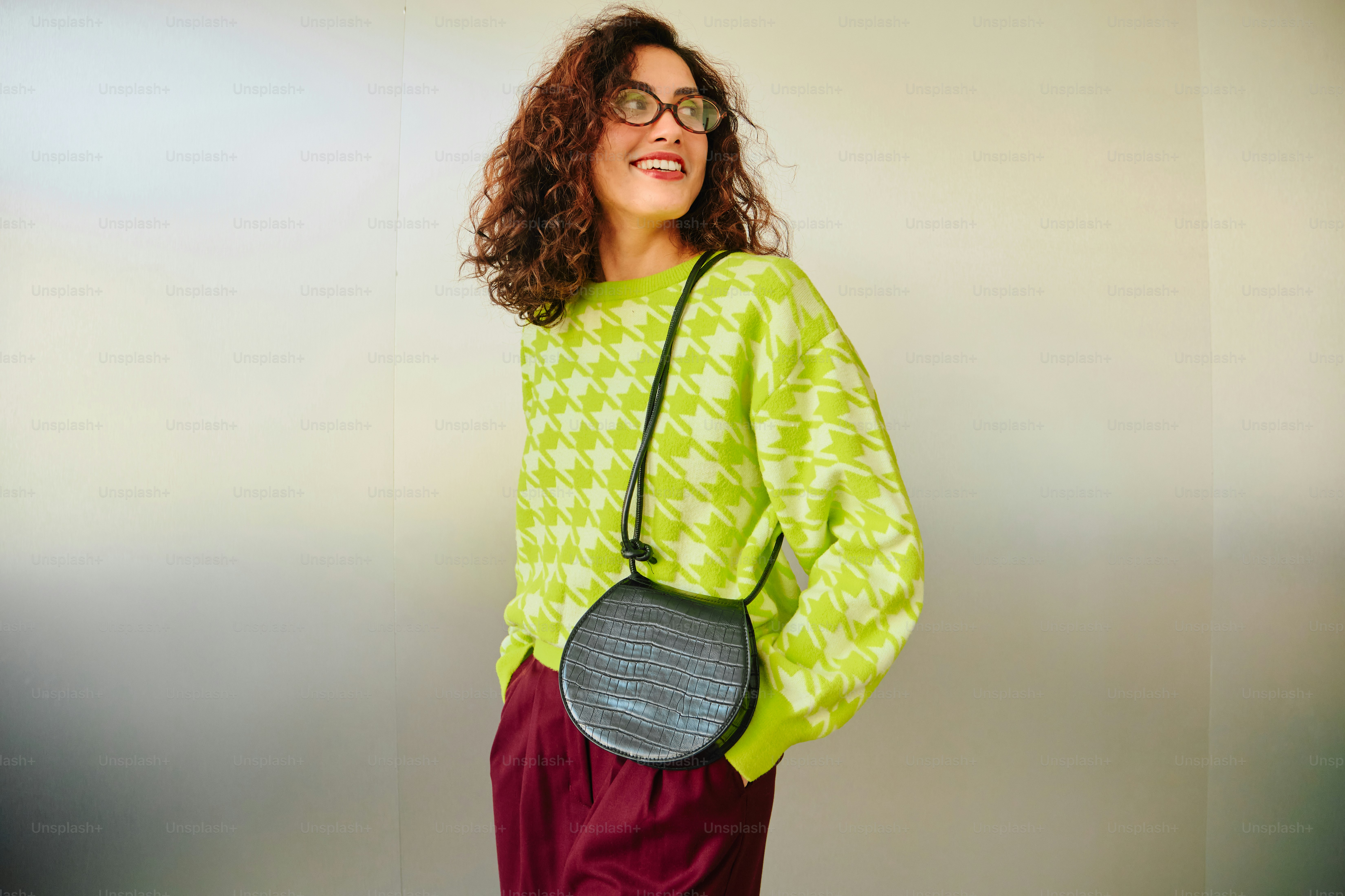 Smiling woman in chartreuse sweater and burgundy pants