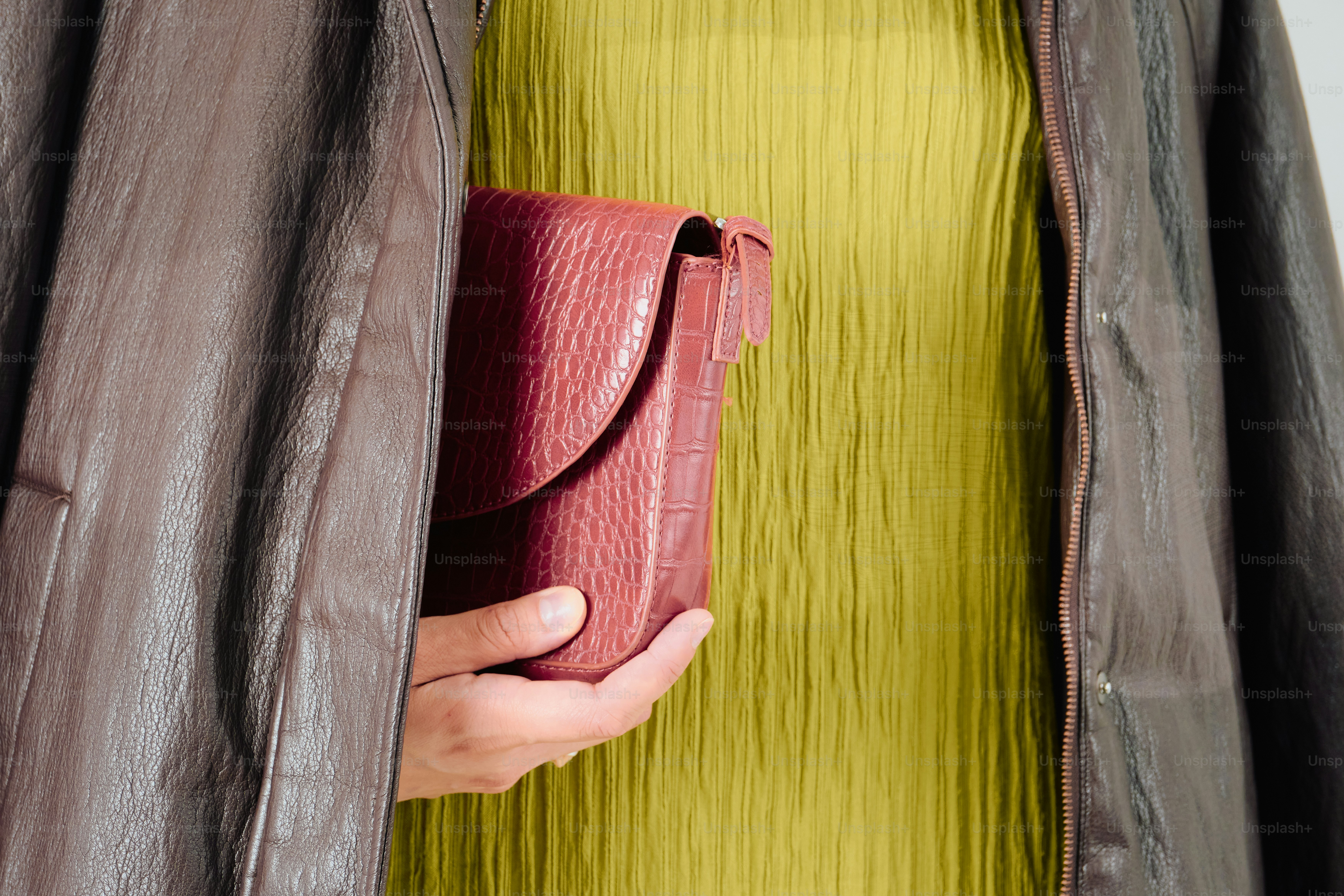 Burgundy clutch with chartreuse dress and brown jacket