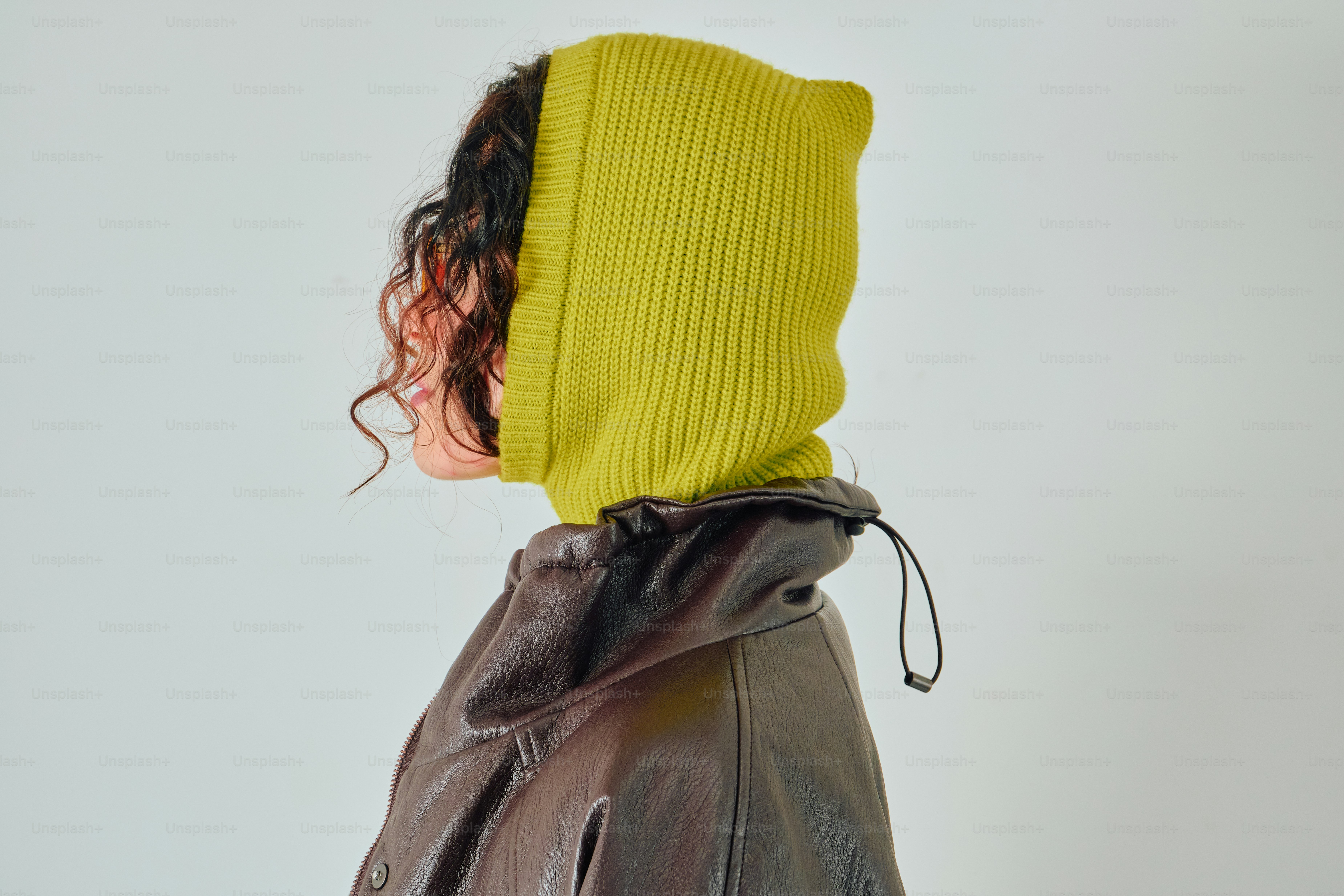 Woman in chartreuse ribbed balaclava and brown jacket