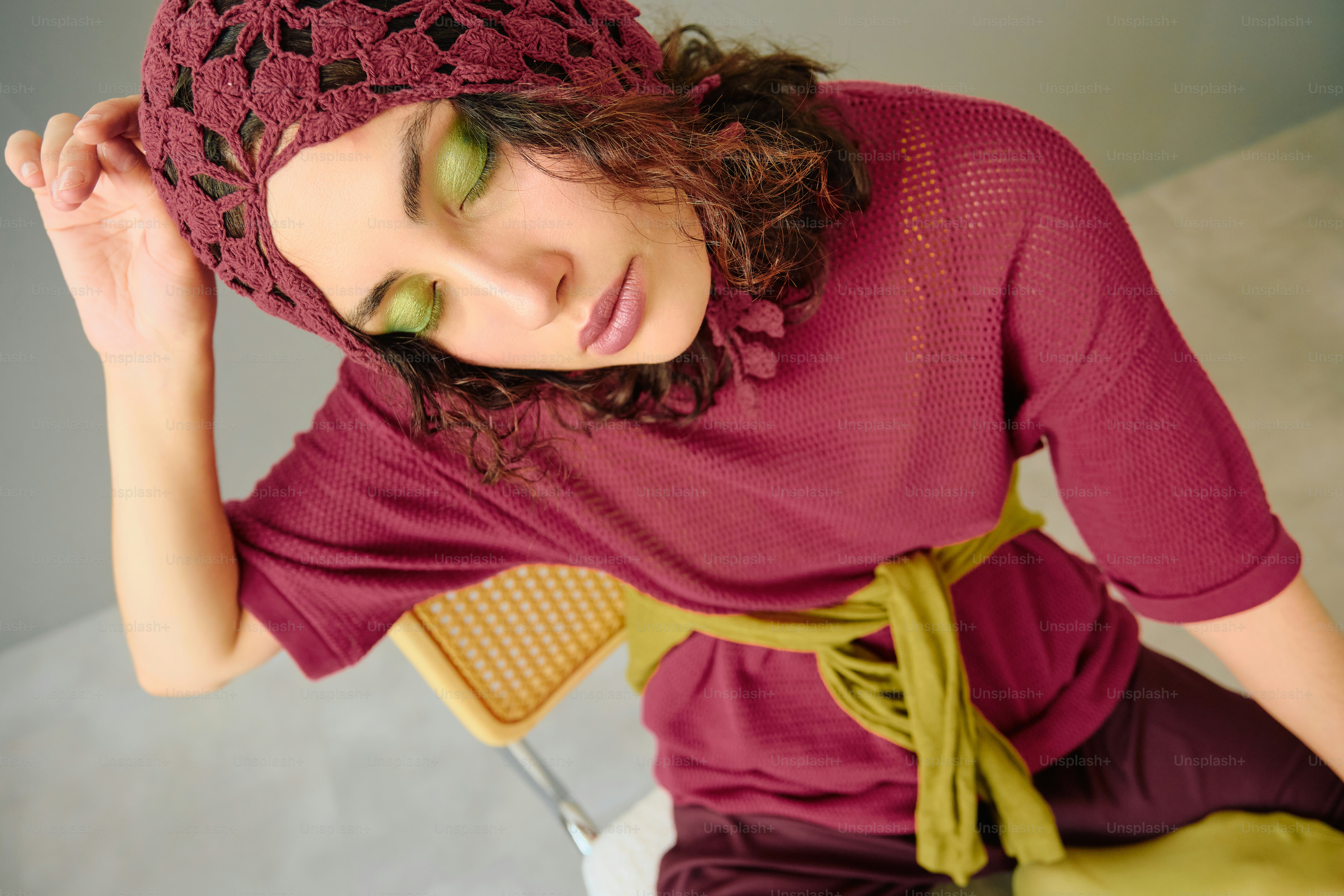 Woman in burgundy top and chartreuse details