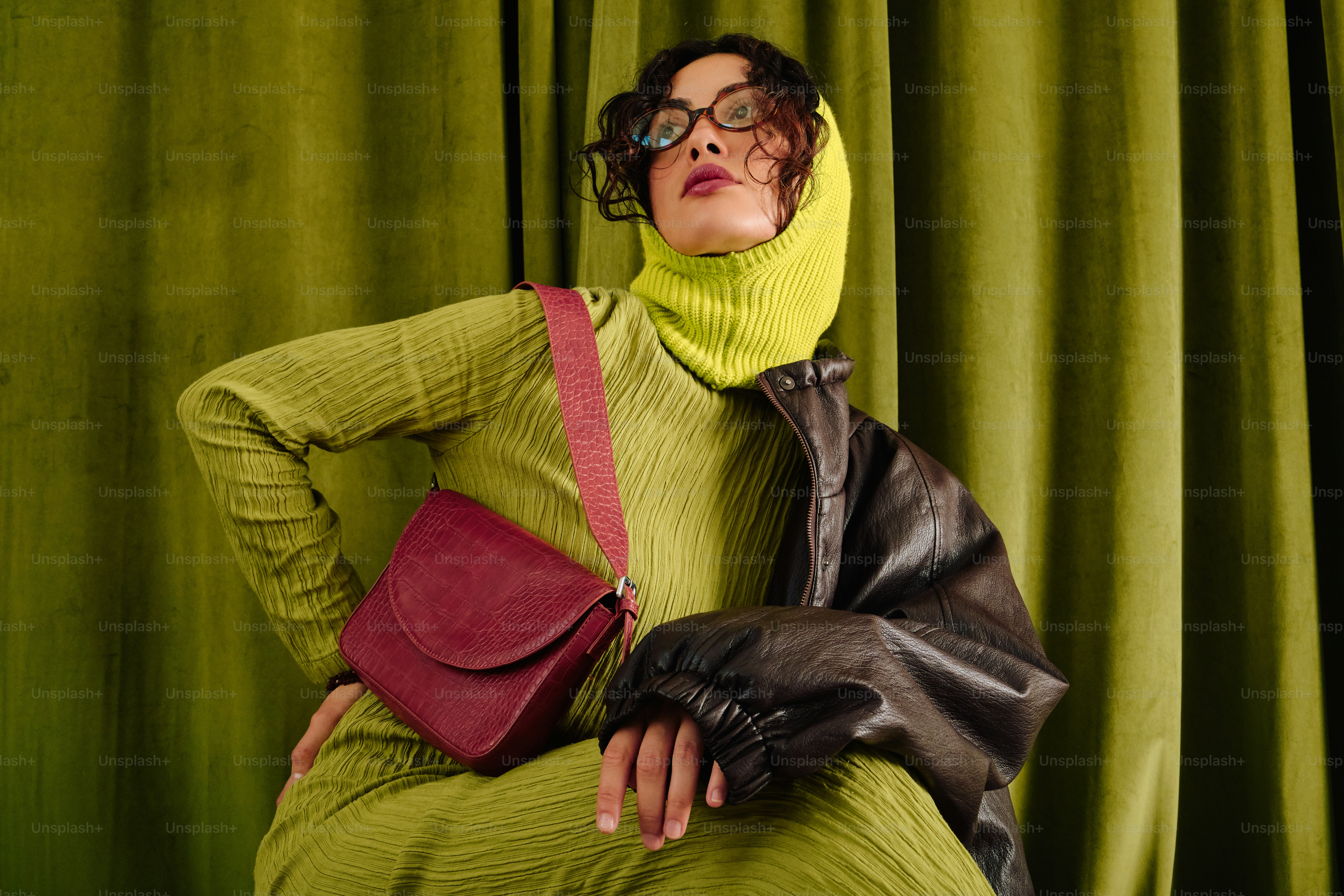 Woman in chartreuse outfit with burgundy bag