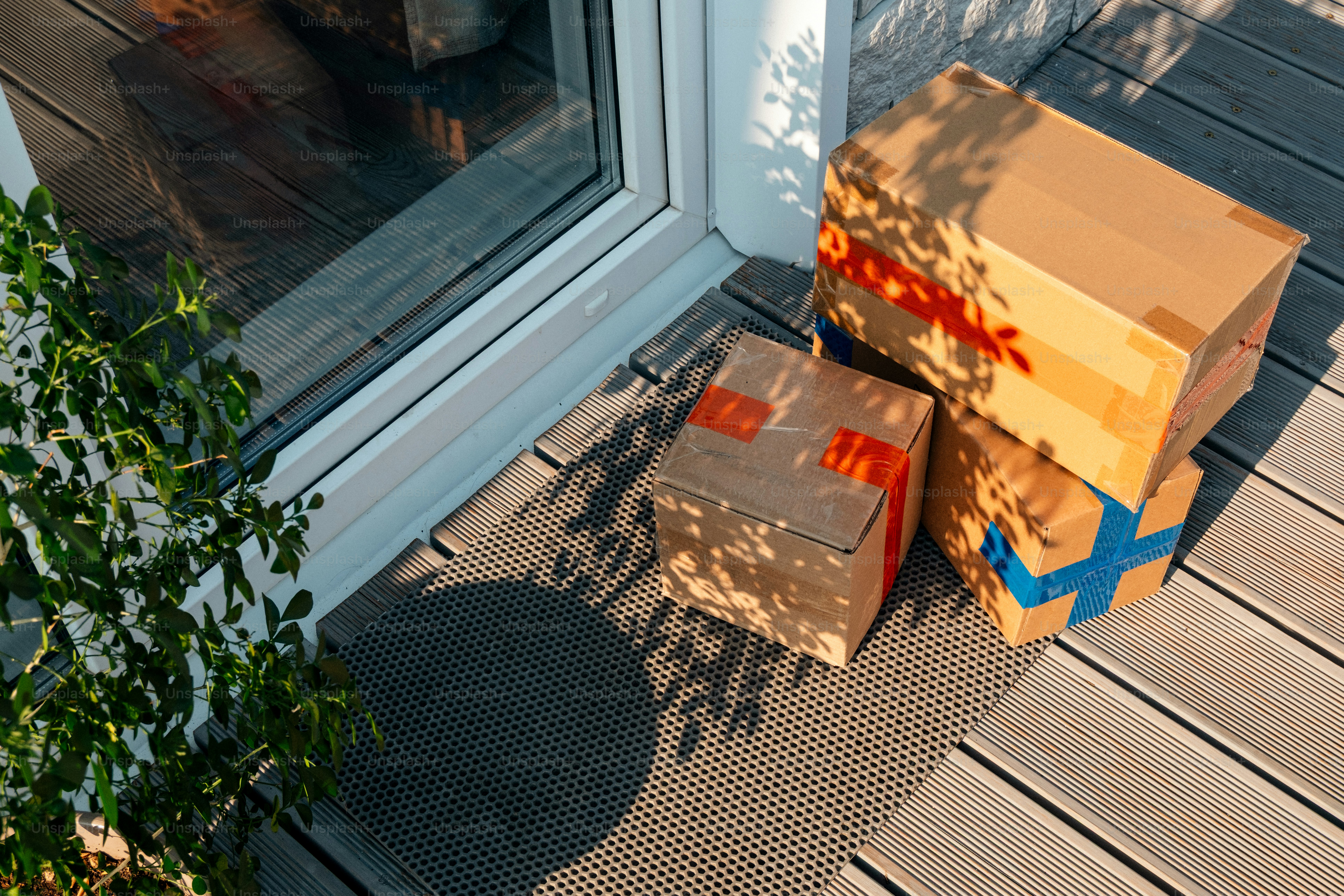 Packages on doorstep in bright sunlight