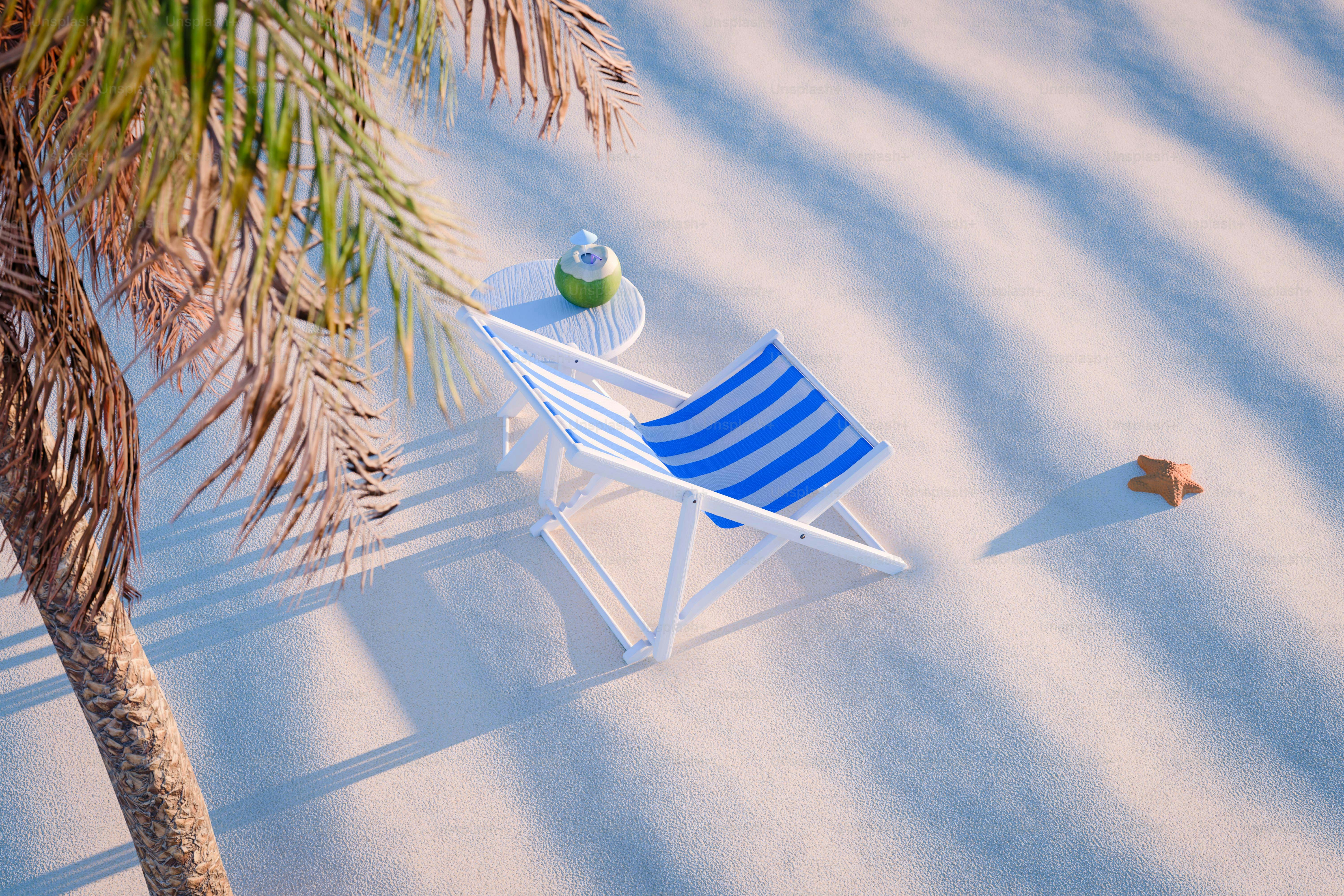 Striped beach chair and drink under palm tree