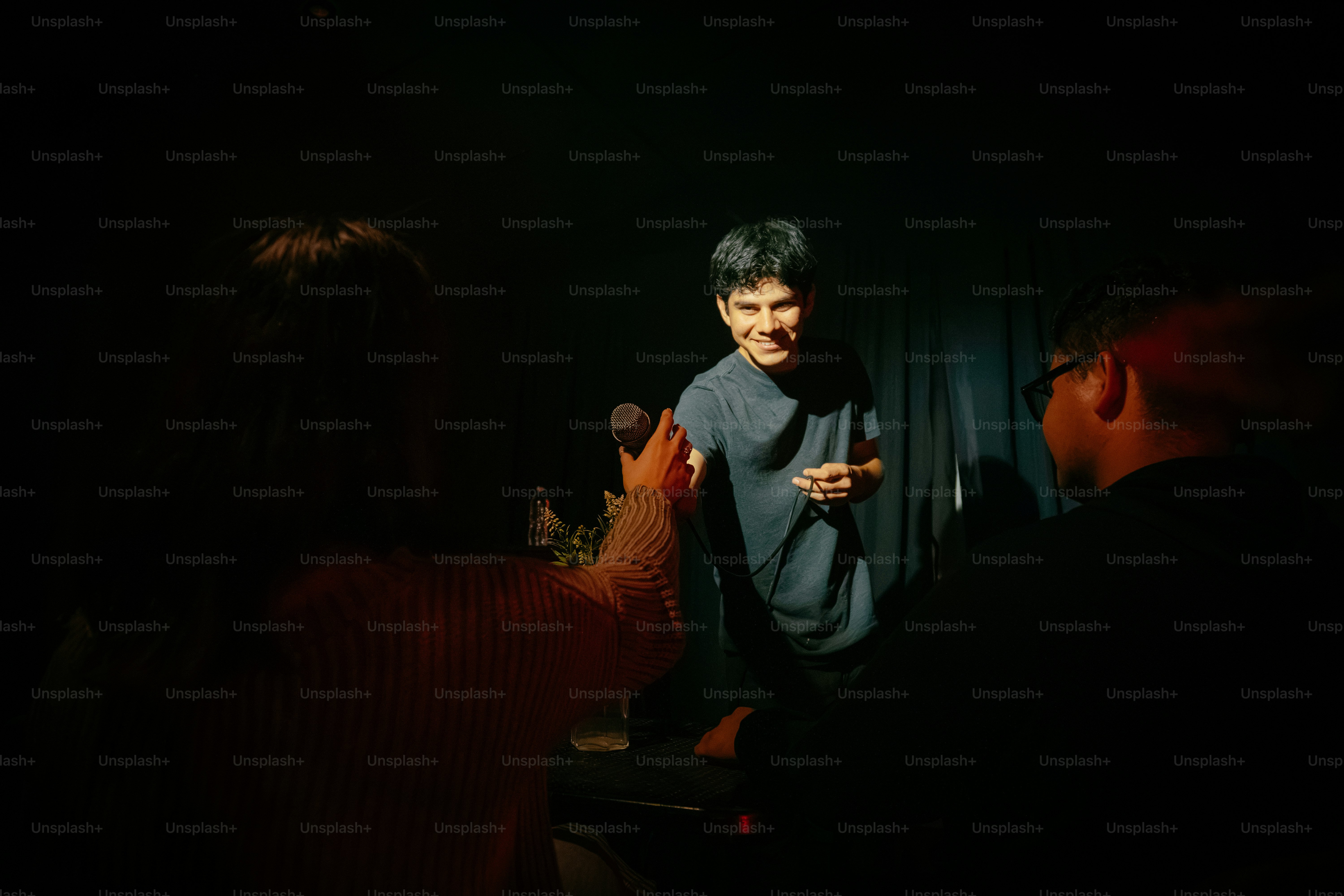 Smiling man on stage performing for an audience
