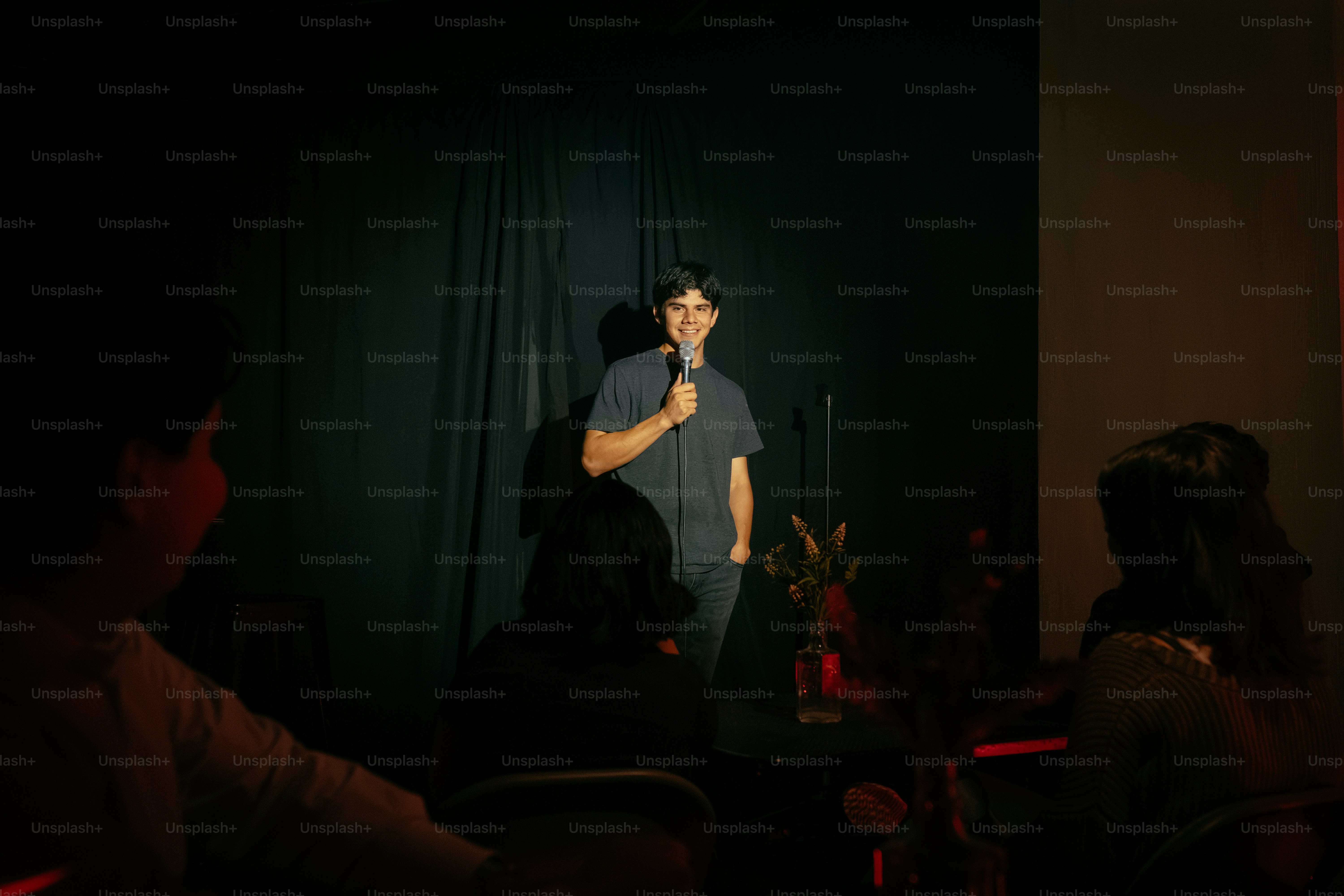 Man performing with microphone on dark stage