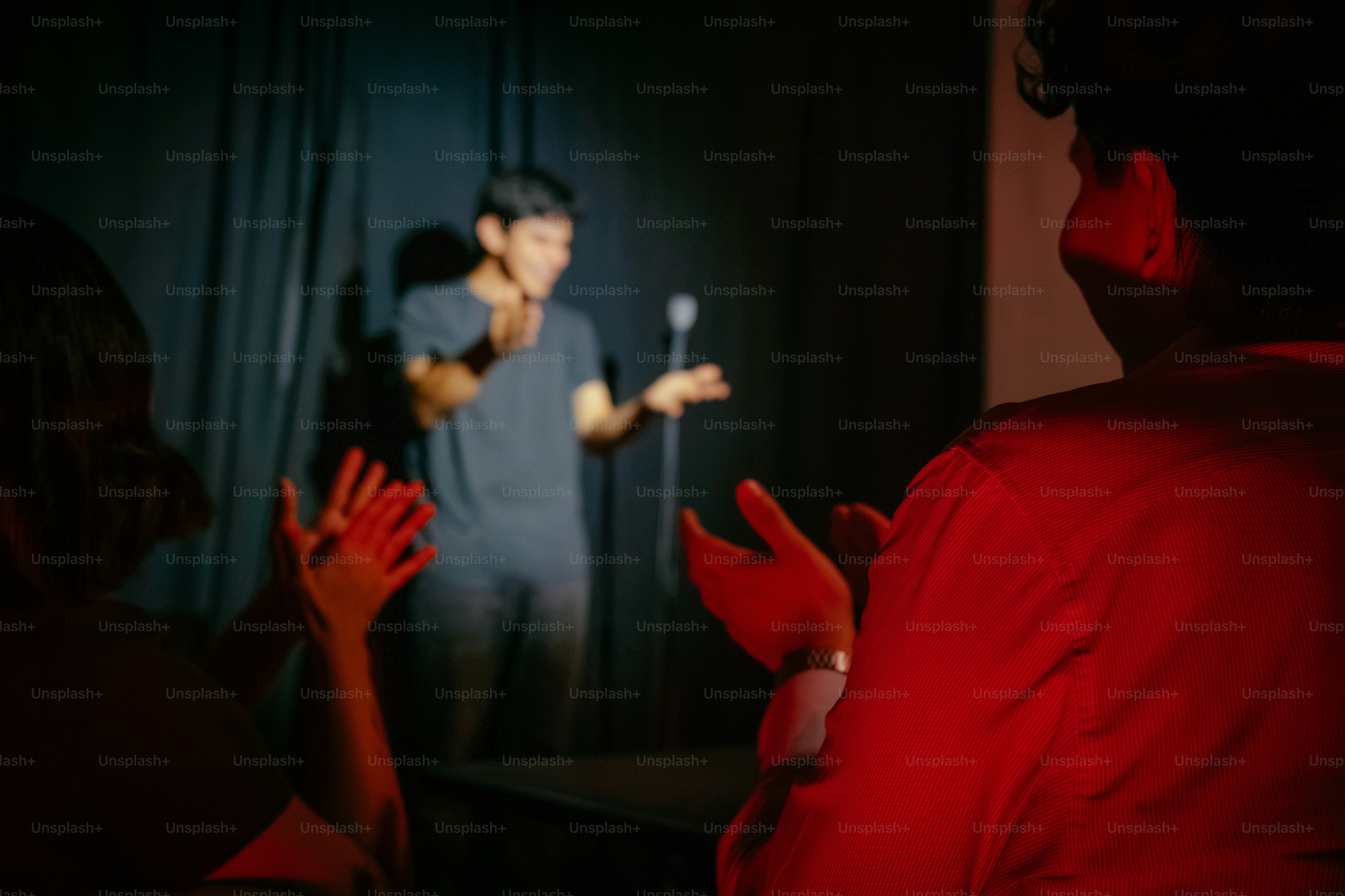 Comedian performing for clapping audience