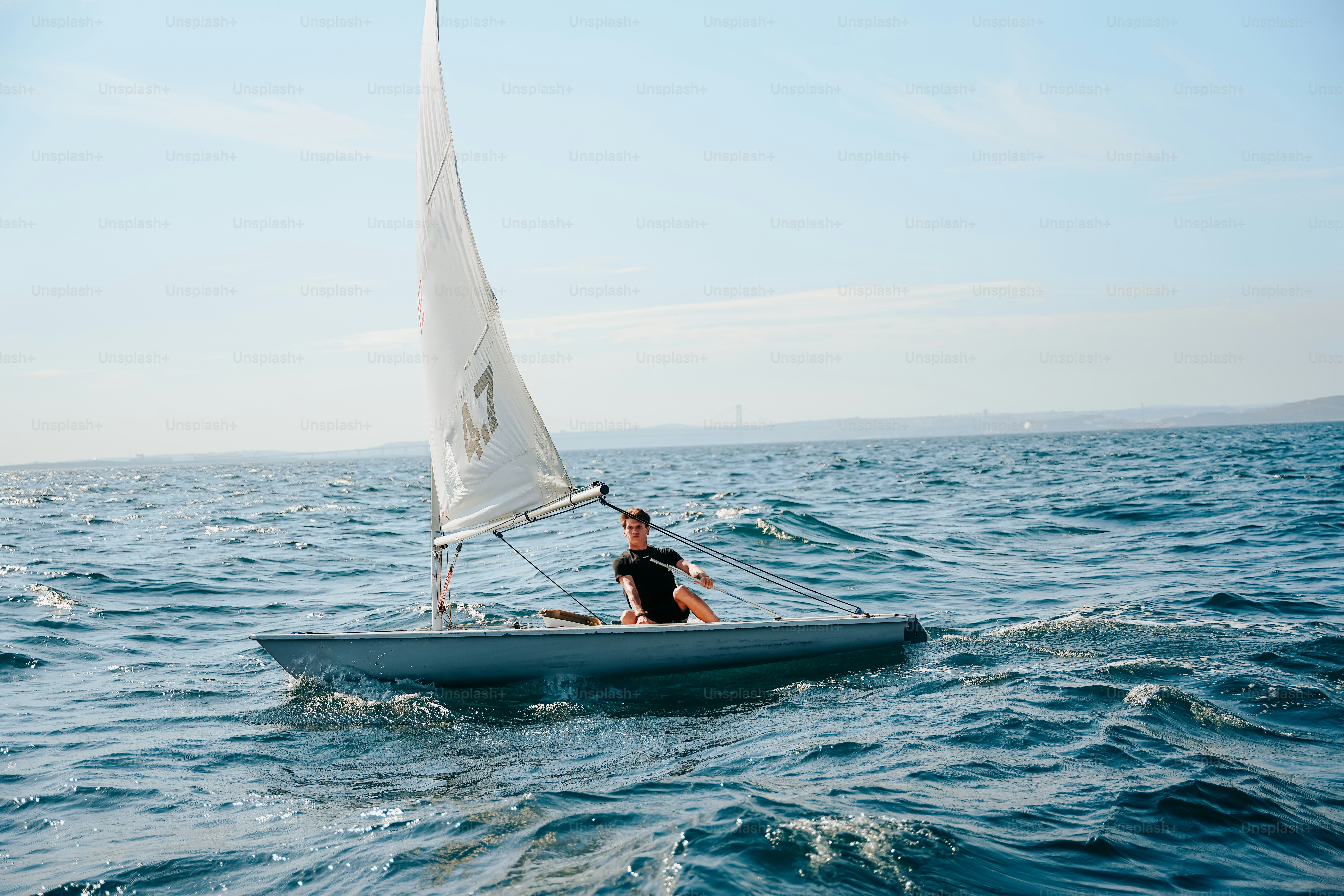 Sailor navigating a small boat on wavy ocean