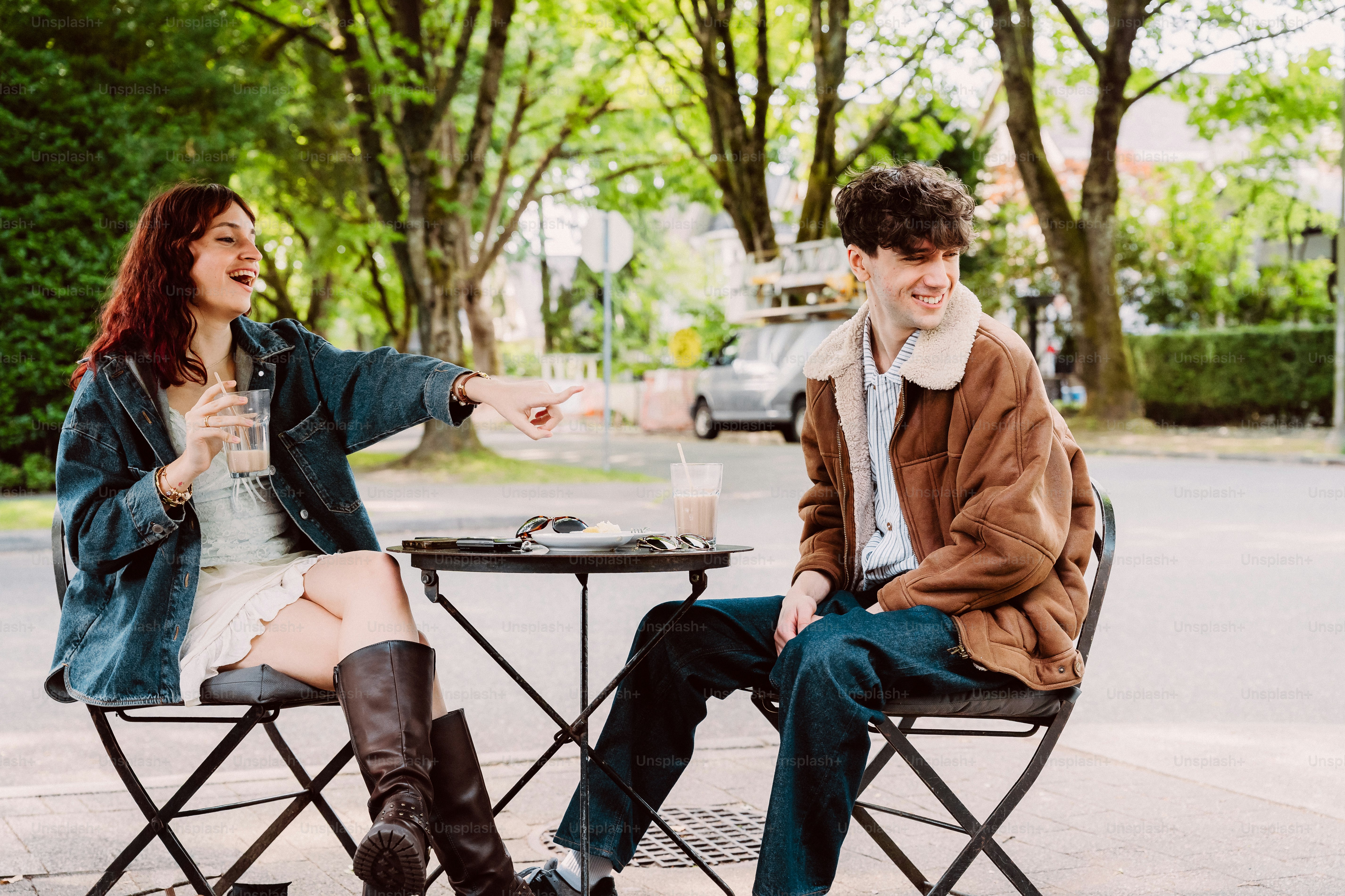 People laughing and pointing at outdoor table