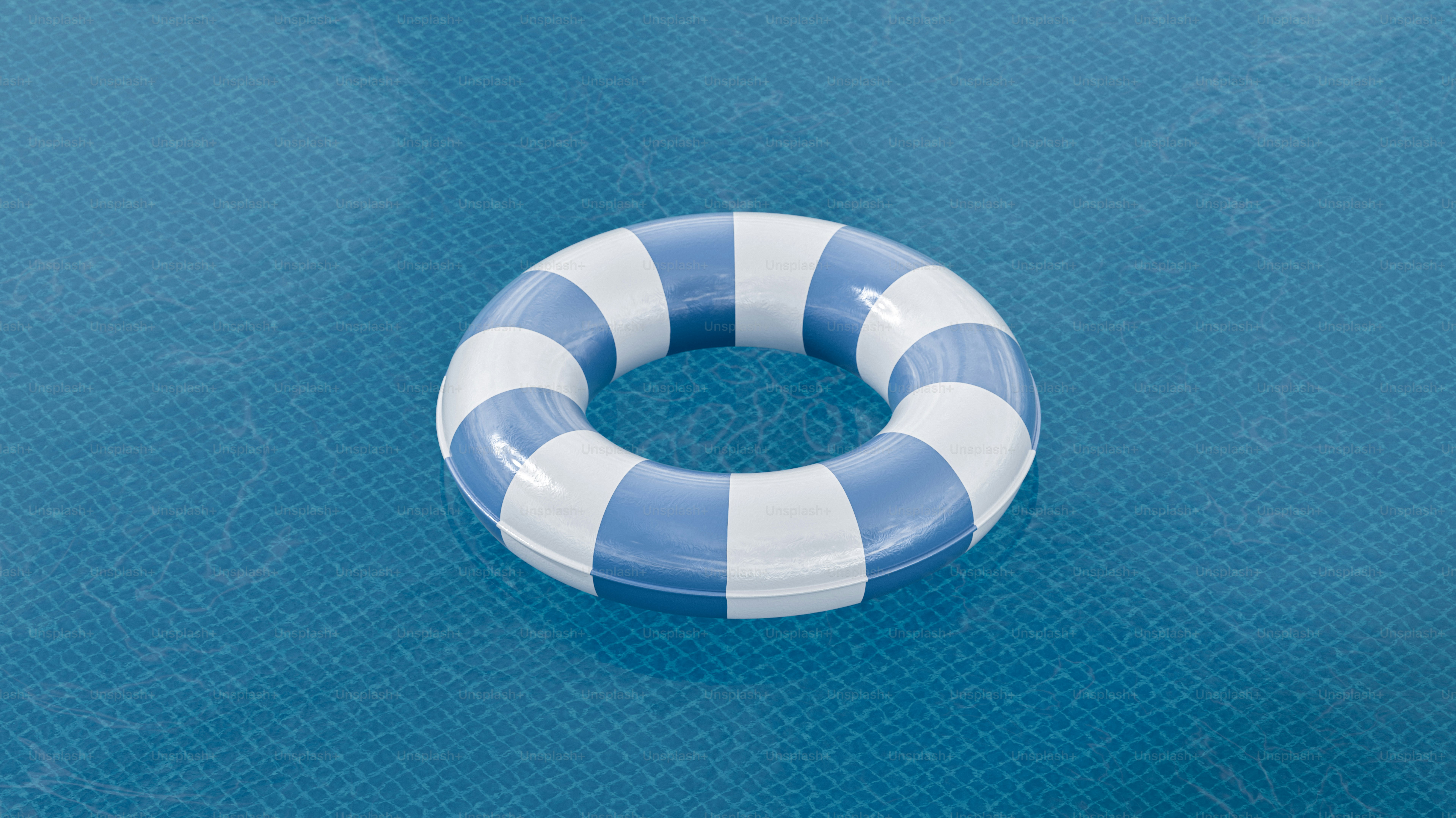 Striped inflatable ring floating on blue water
