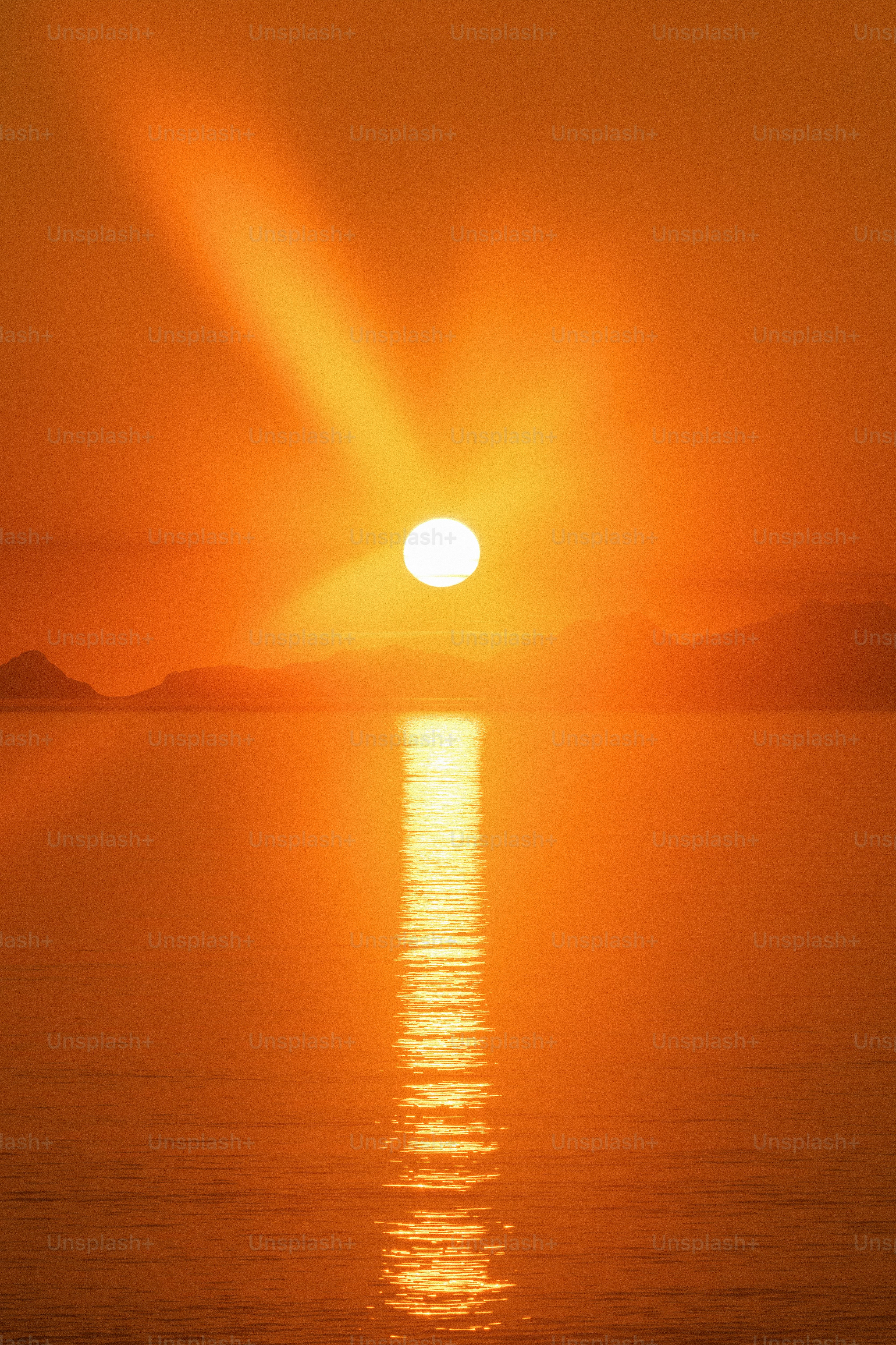 Orange sunset over calm water with sun reflection photo – Sunset Image ...