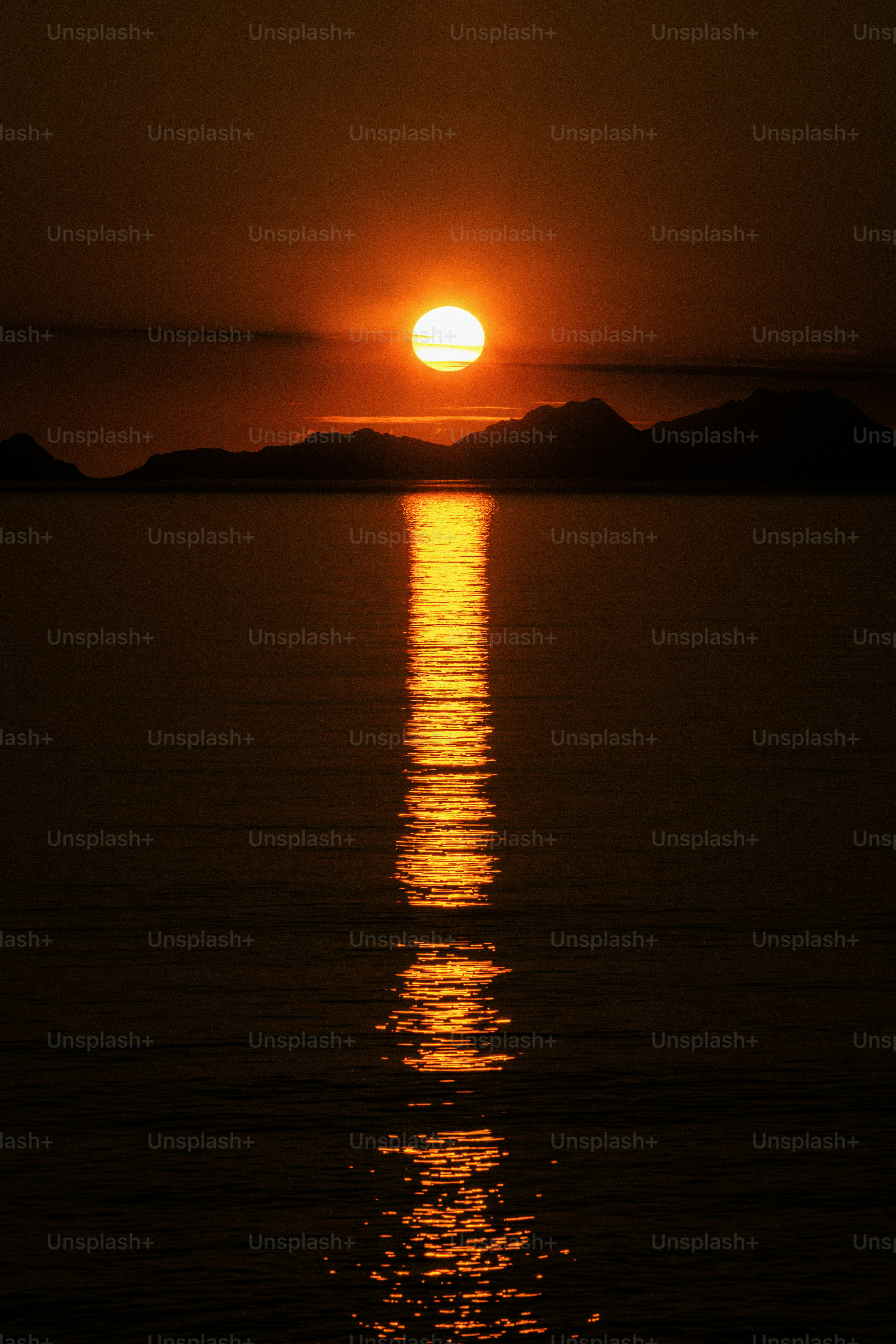 Orange sunset over calm water with sun reflection photo – Sunset Image ...