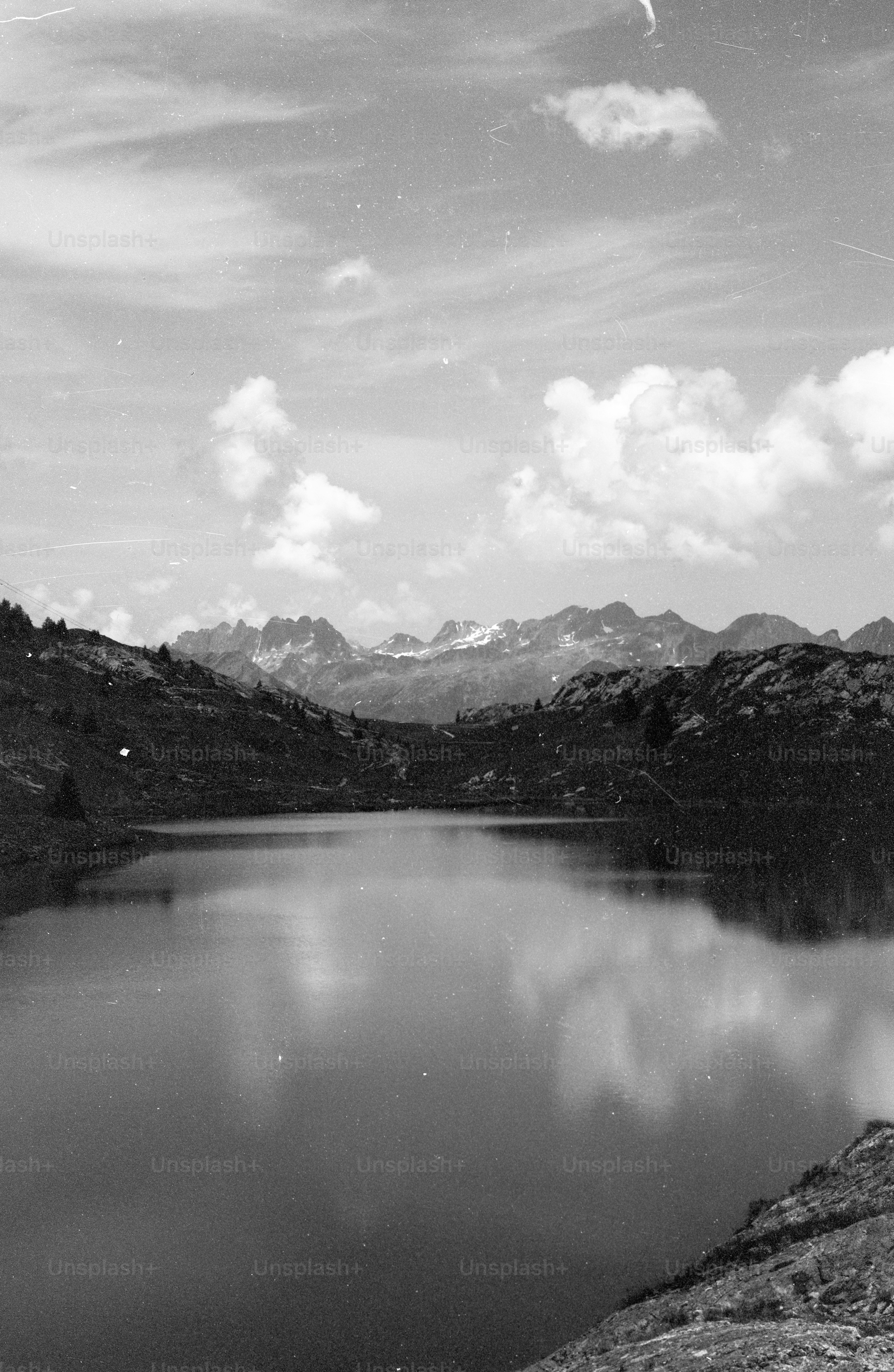 Mountain lake reflecting clouds in black and white