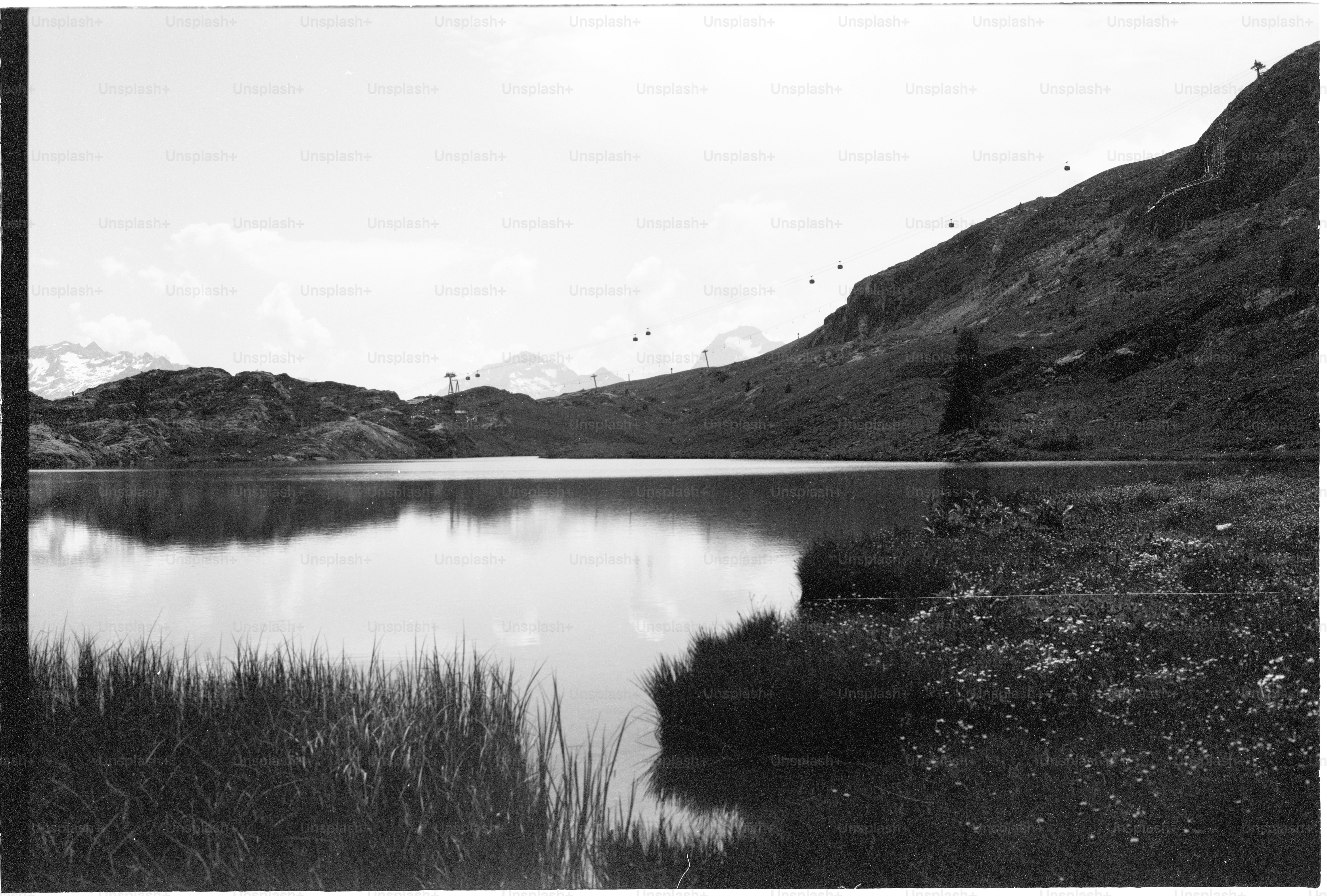 Mountain lake with calm water and grassy shore
