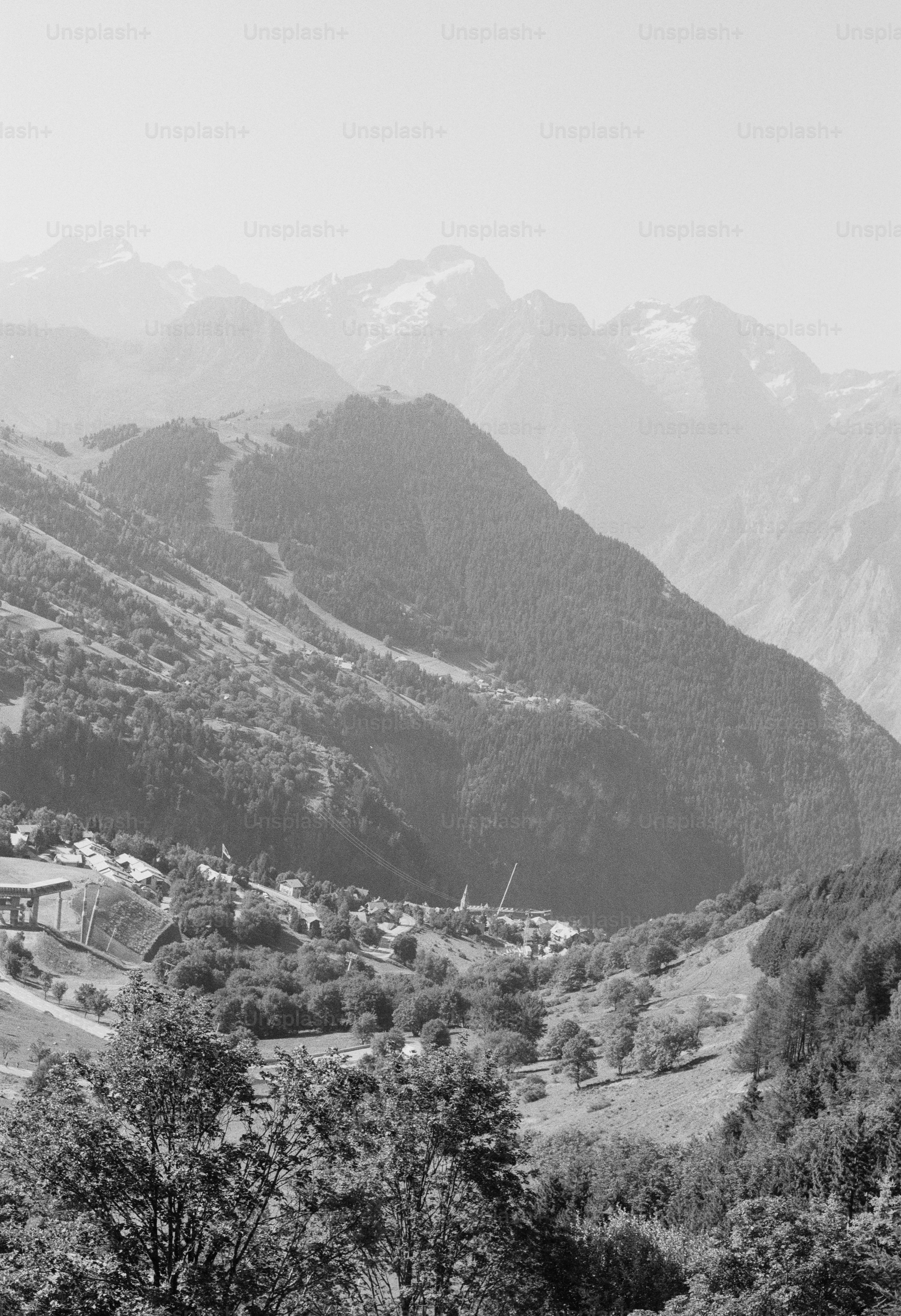 Mountain valley with village amidst hazy peaks
