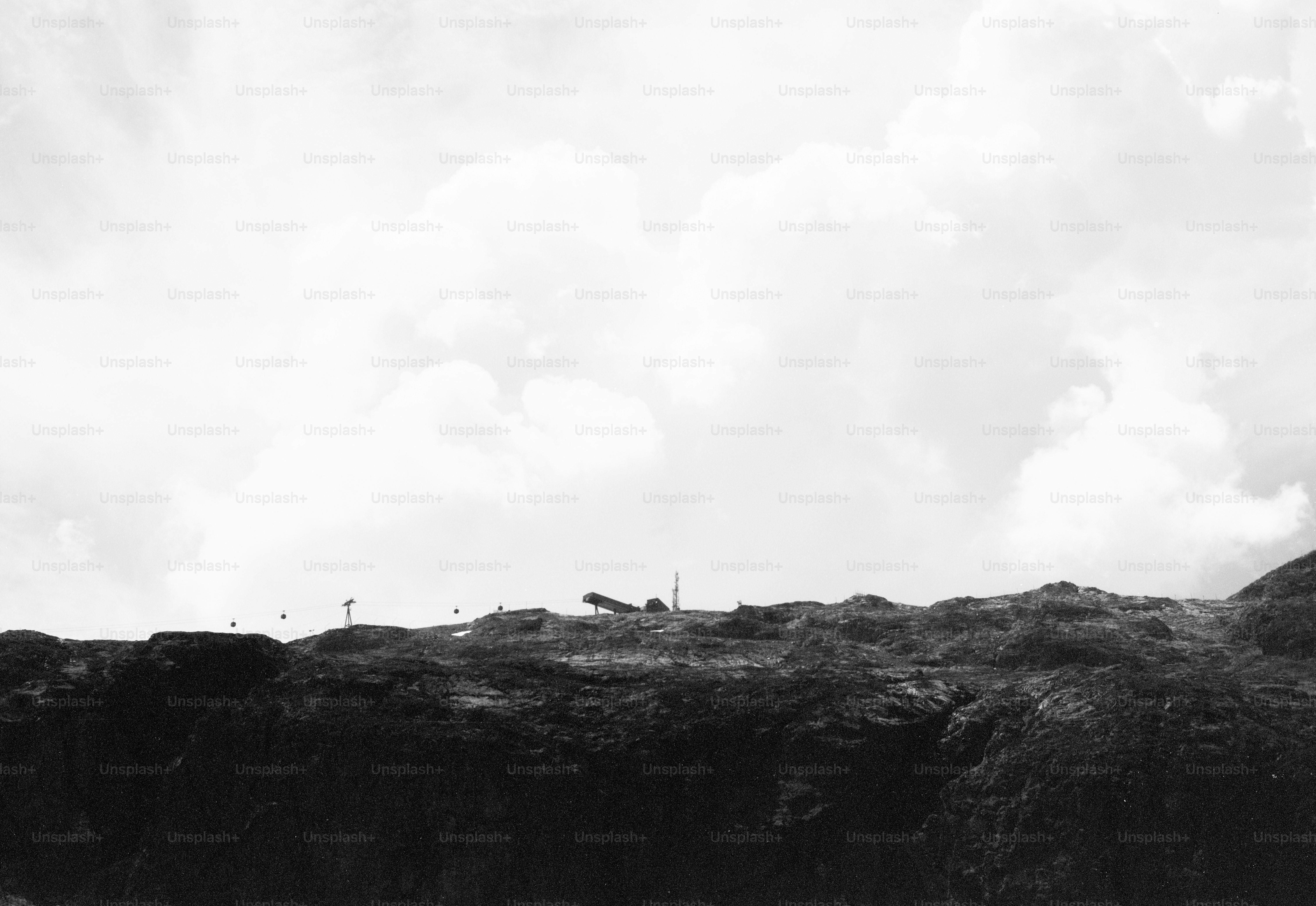 Cannon on dark cliff under vast cloudy sky