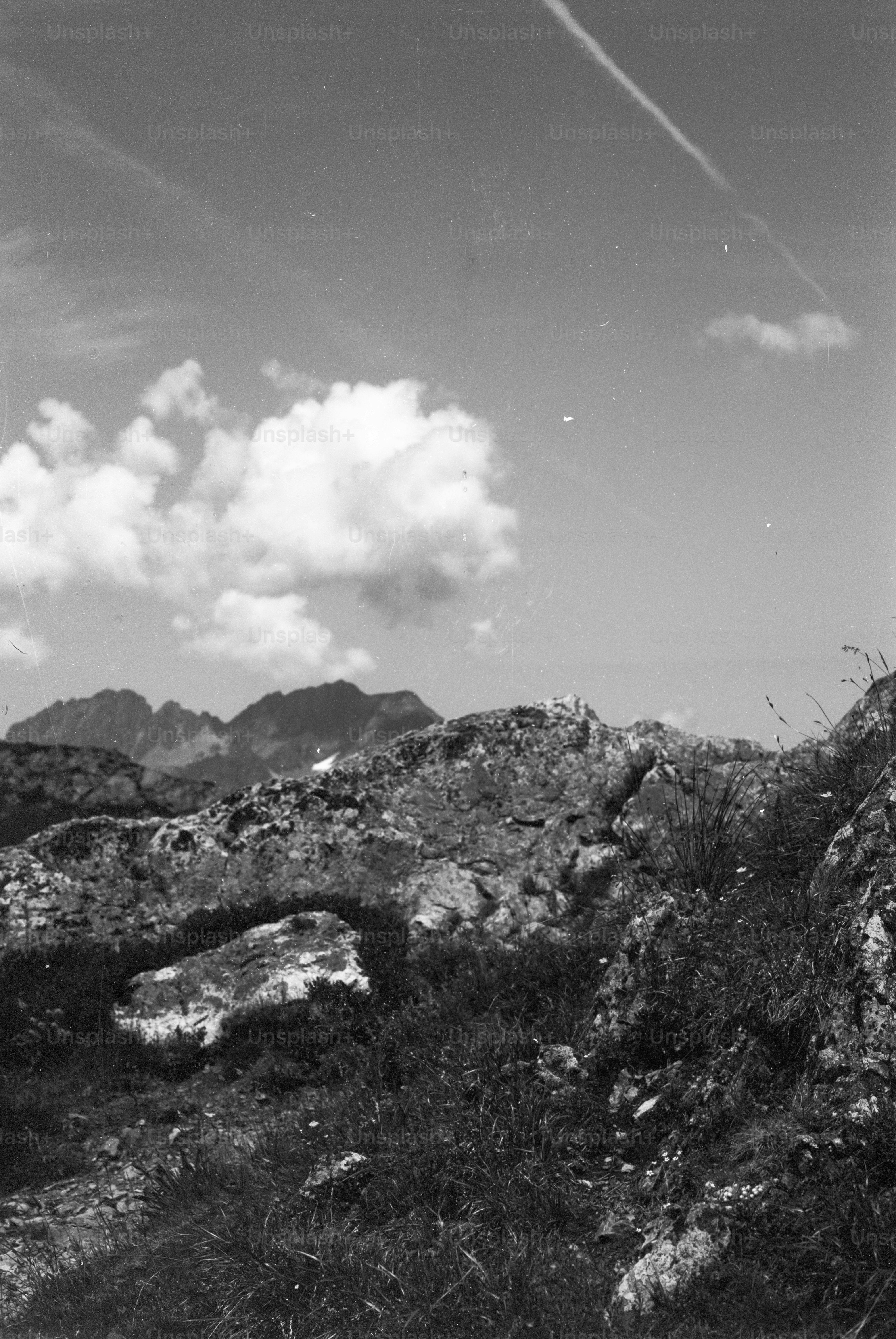 Rocky foreground with distant mountains and cloudy sky