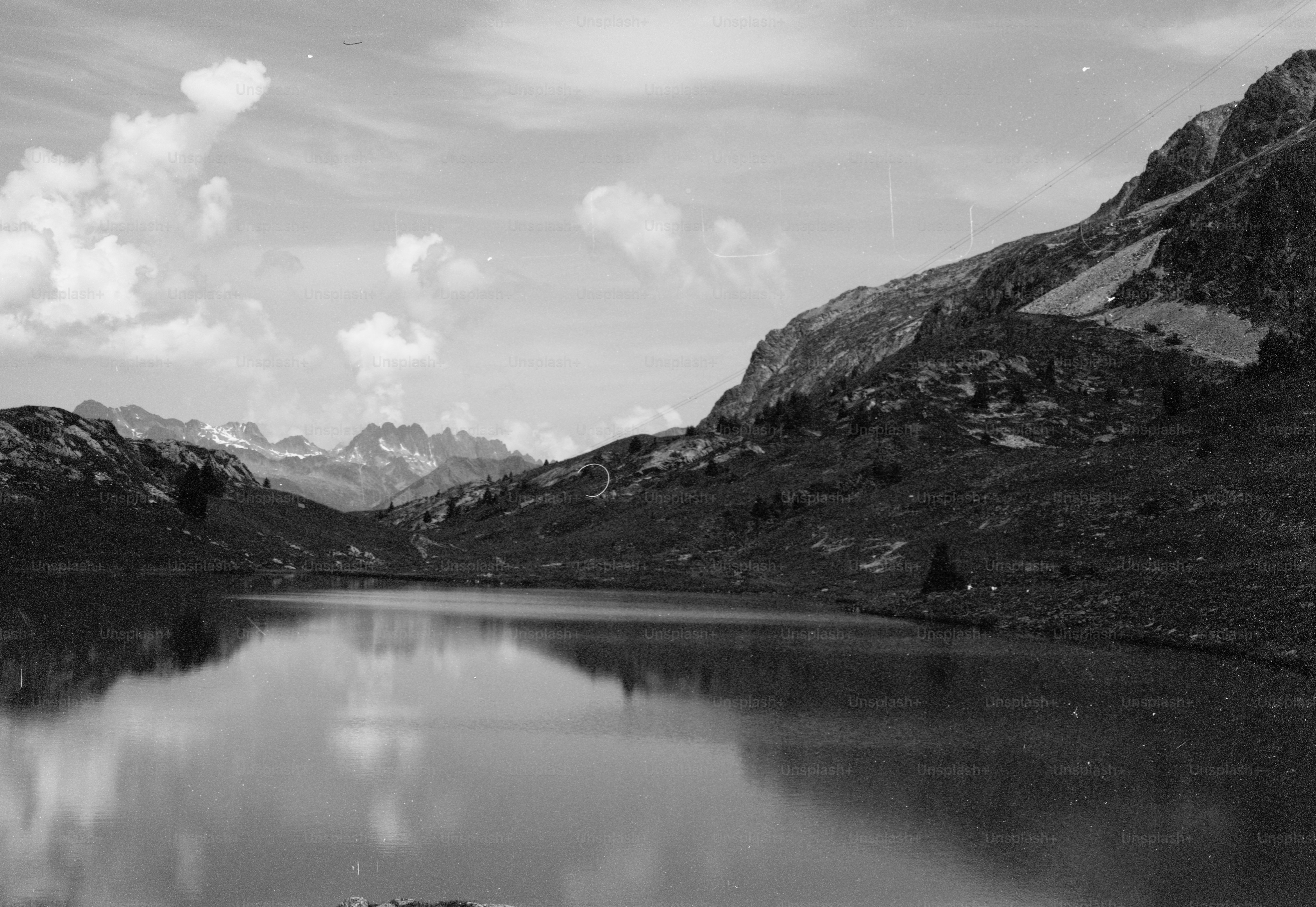 Lake reflecting mountains under cloudy sky