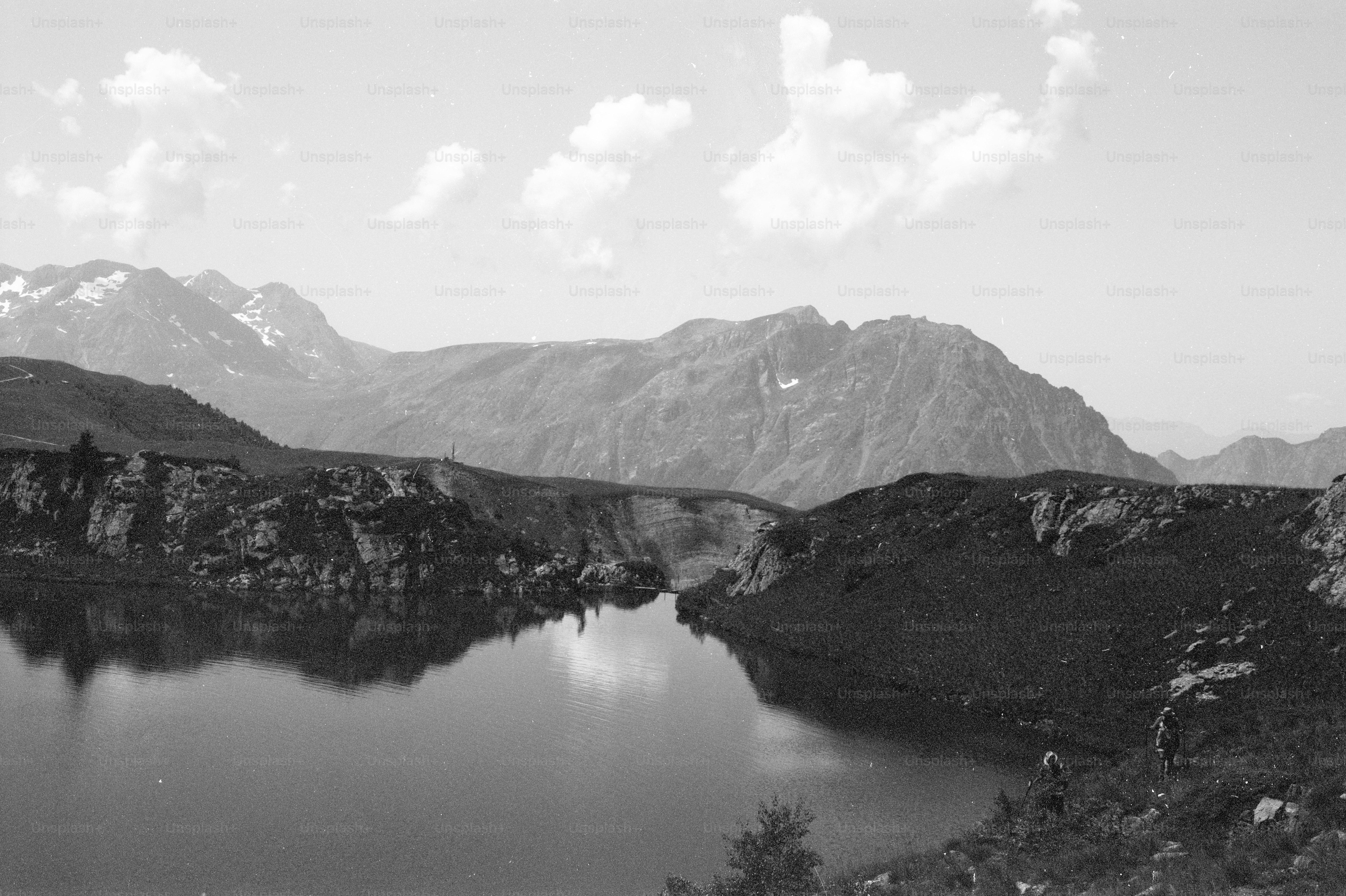 Black and white mountain lake with rocky banks