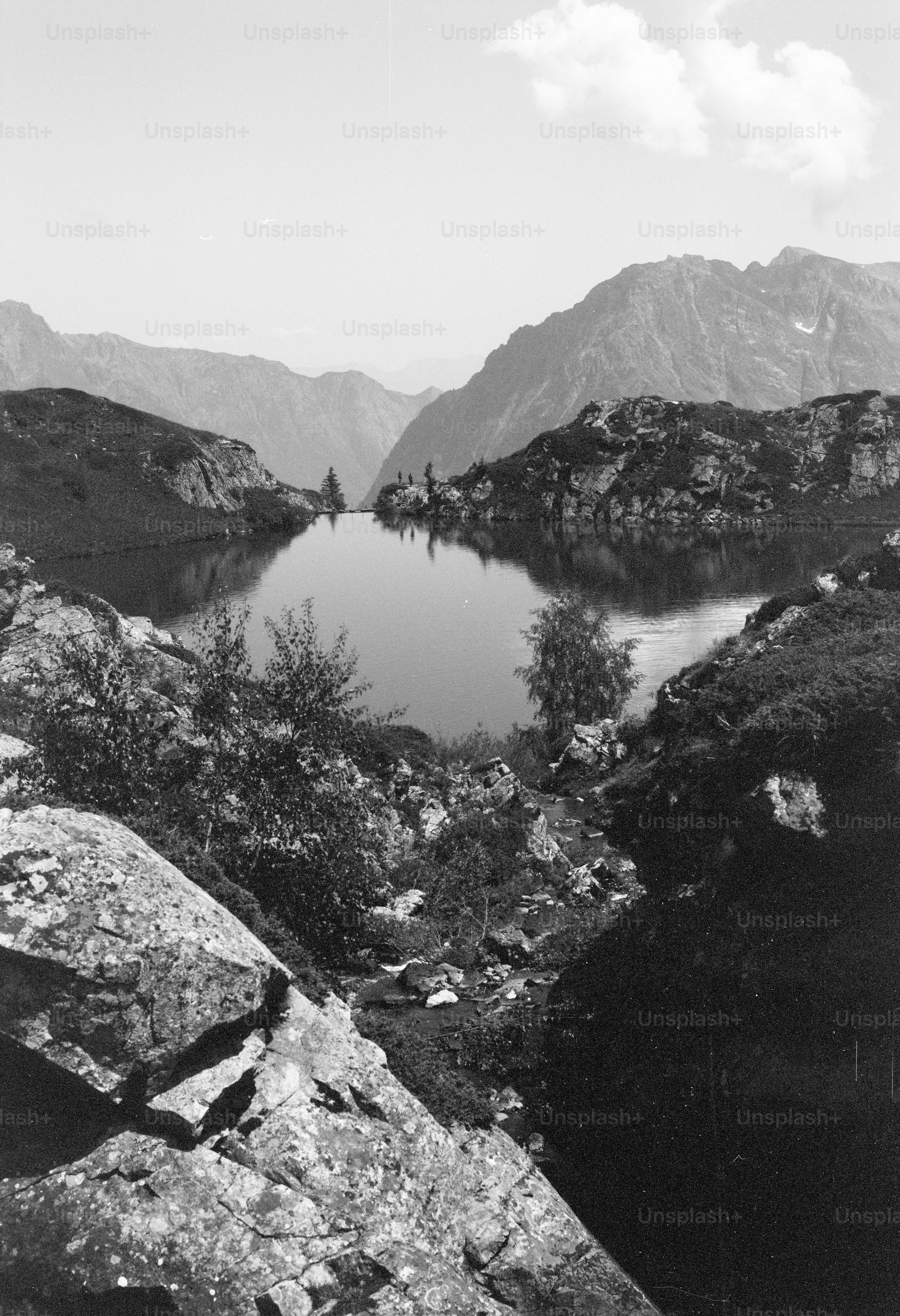 Mountain lake reflecting sky in rocky landscape