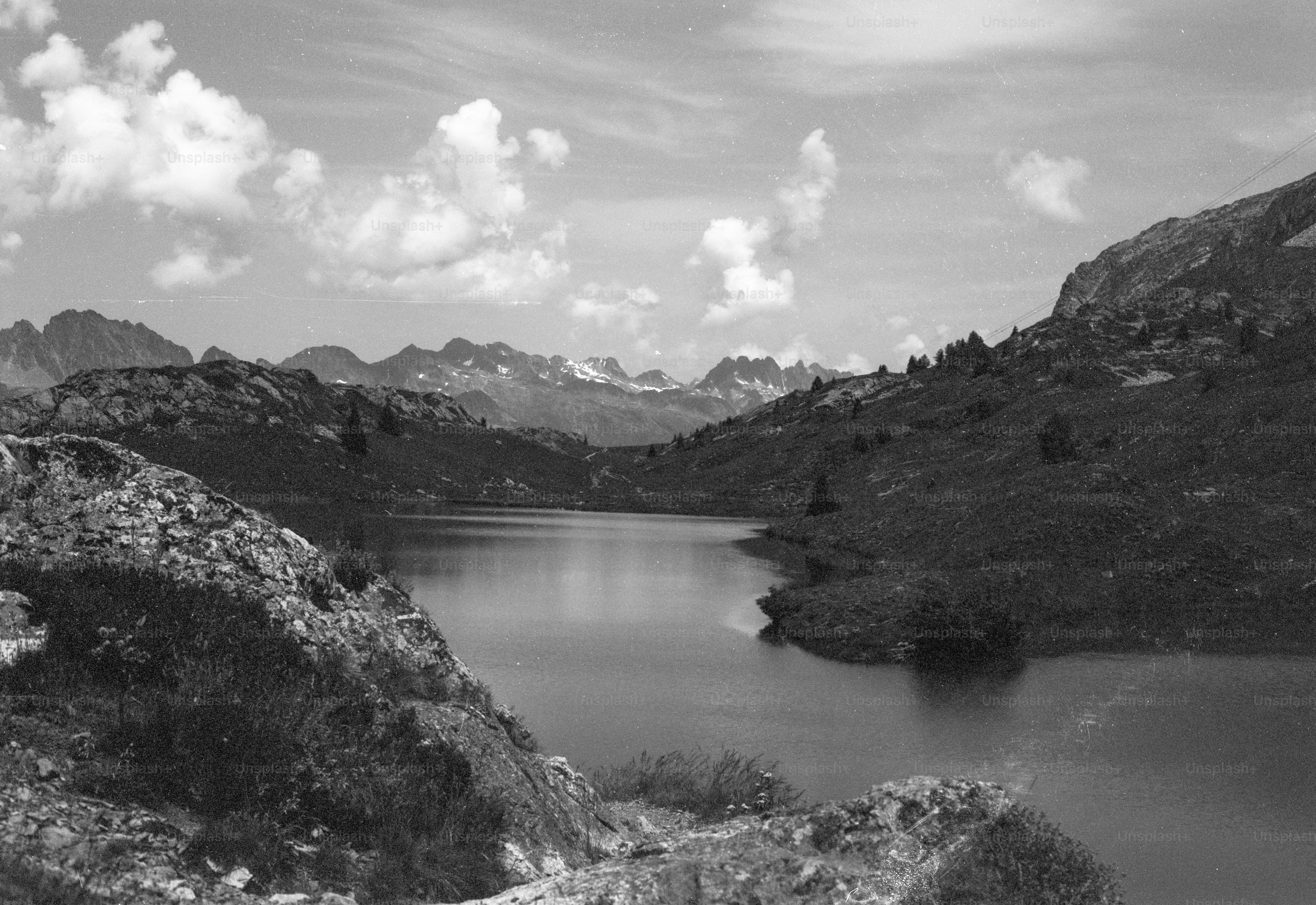 Monochrome mountain lake under a cloudy sky