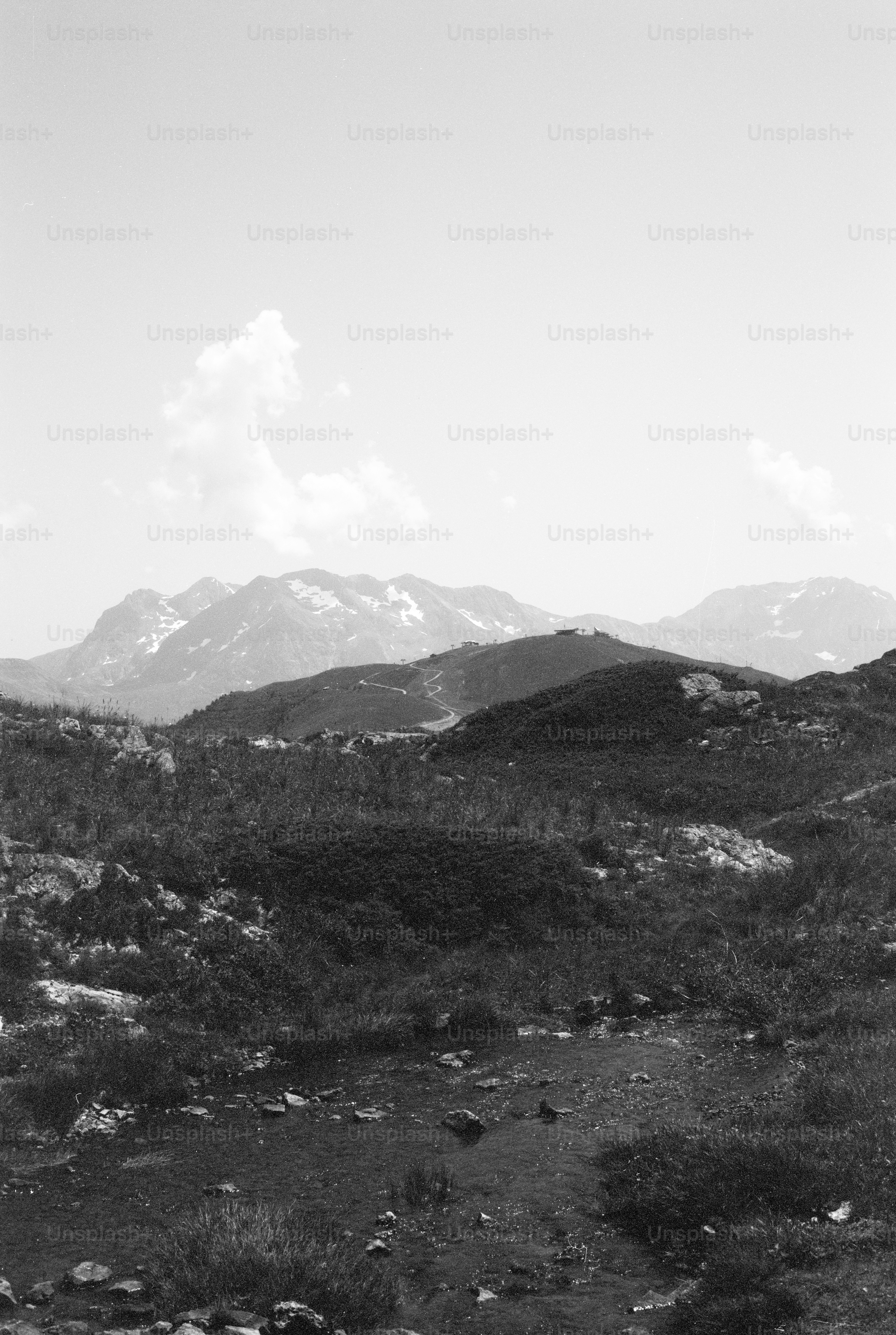 Black and white mountain landscape with rocky foreground