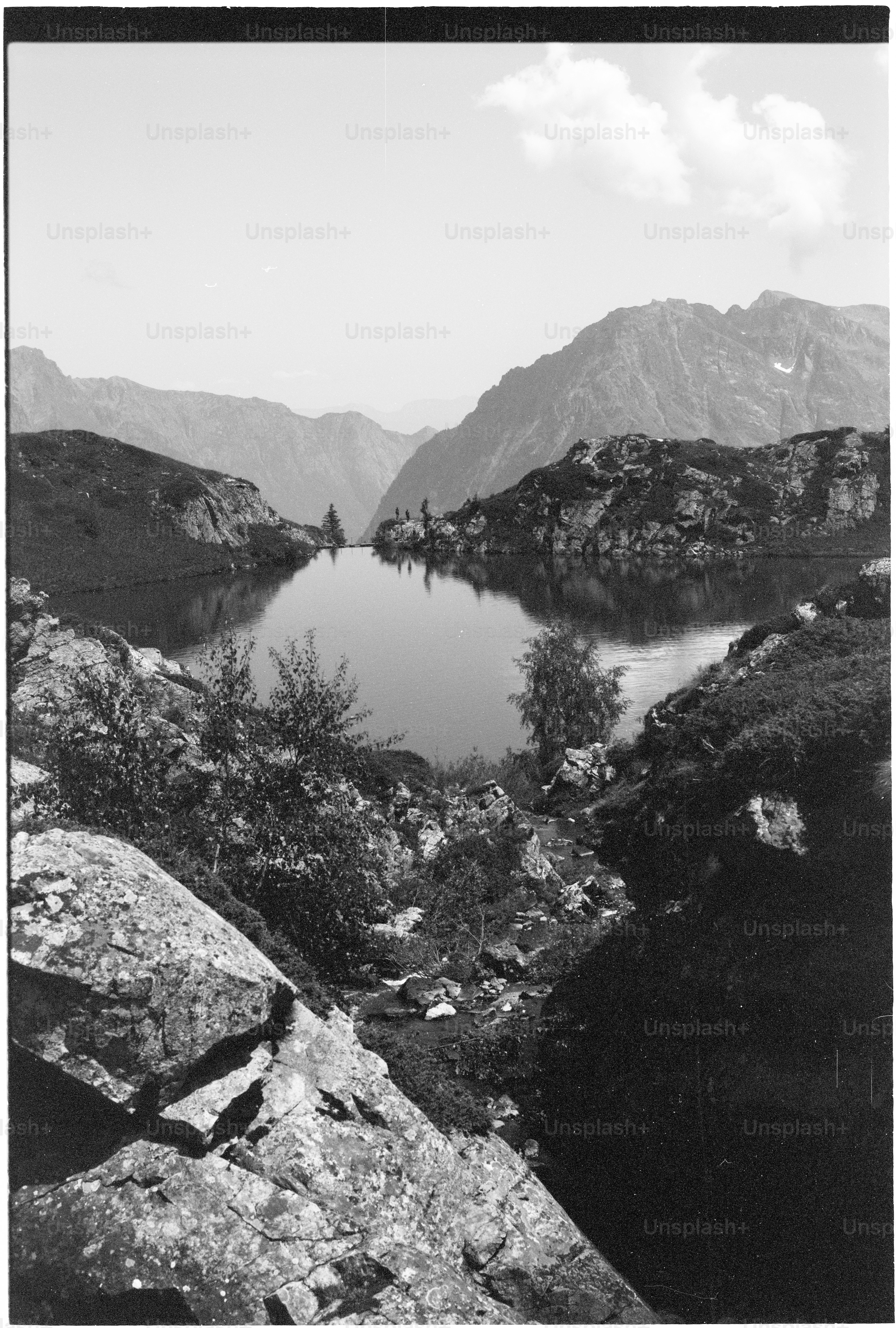 Black and white mountain lake with rocky shores