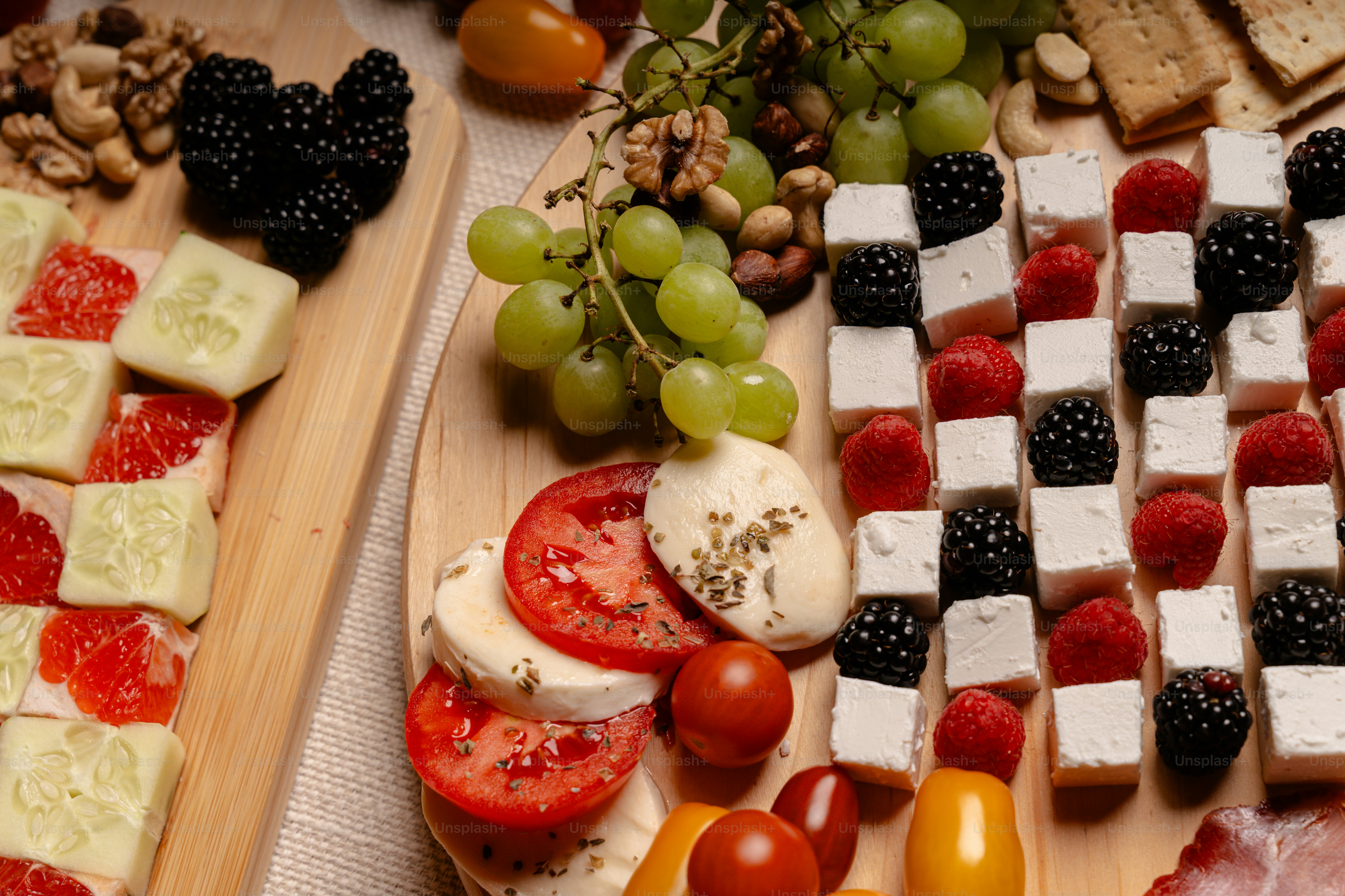 Colorful appetizer board featuring cheese, fruit, and vegetables