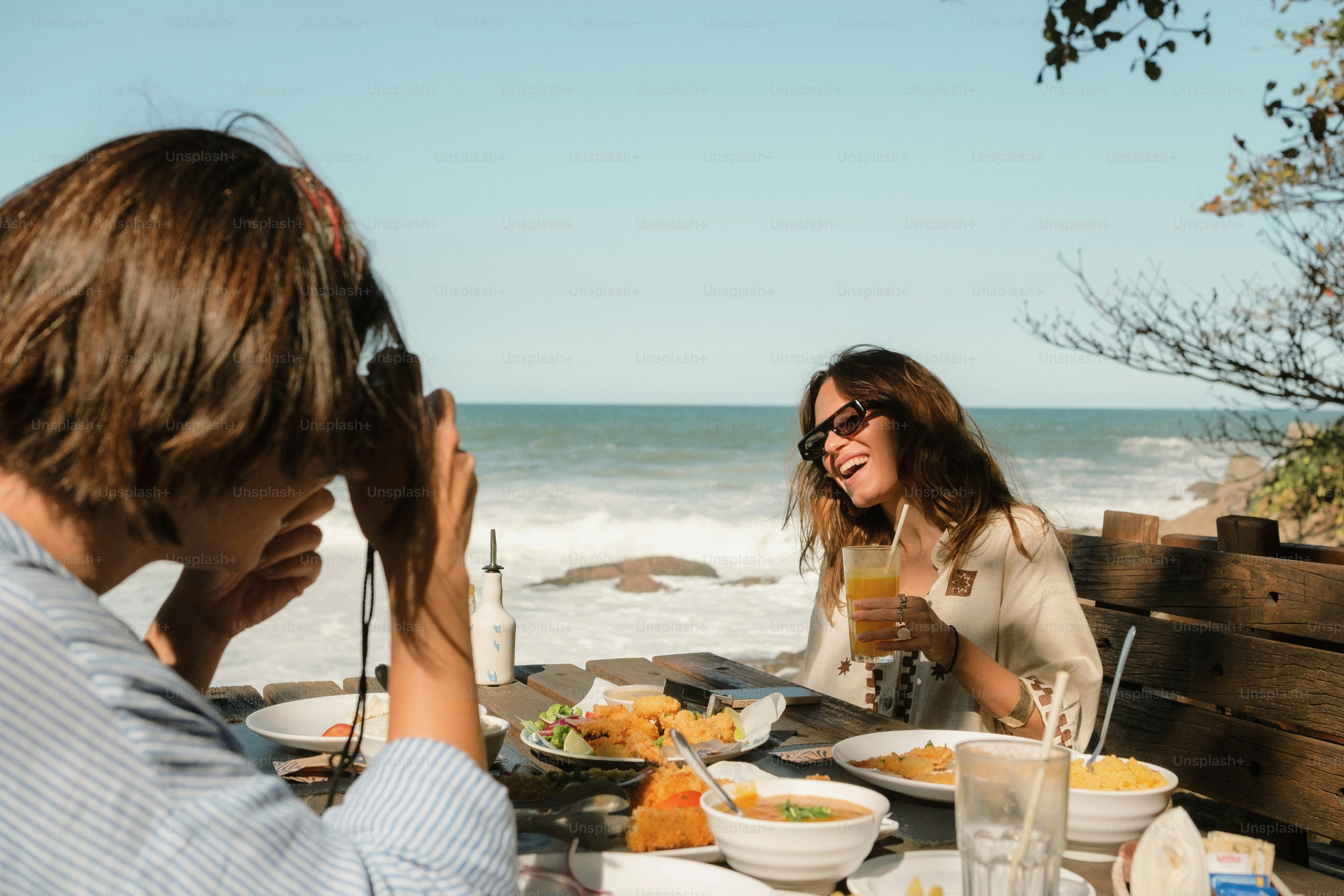 Women enjoying a meal at a beachside restaurant