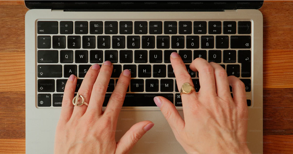 Hands typing on a laptop keyboard photo – Technology Image on Unsplash