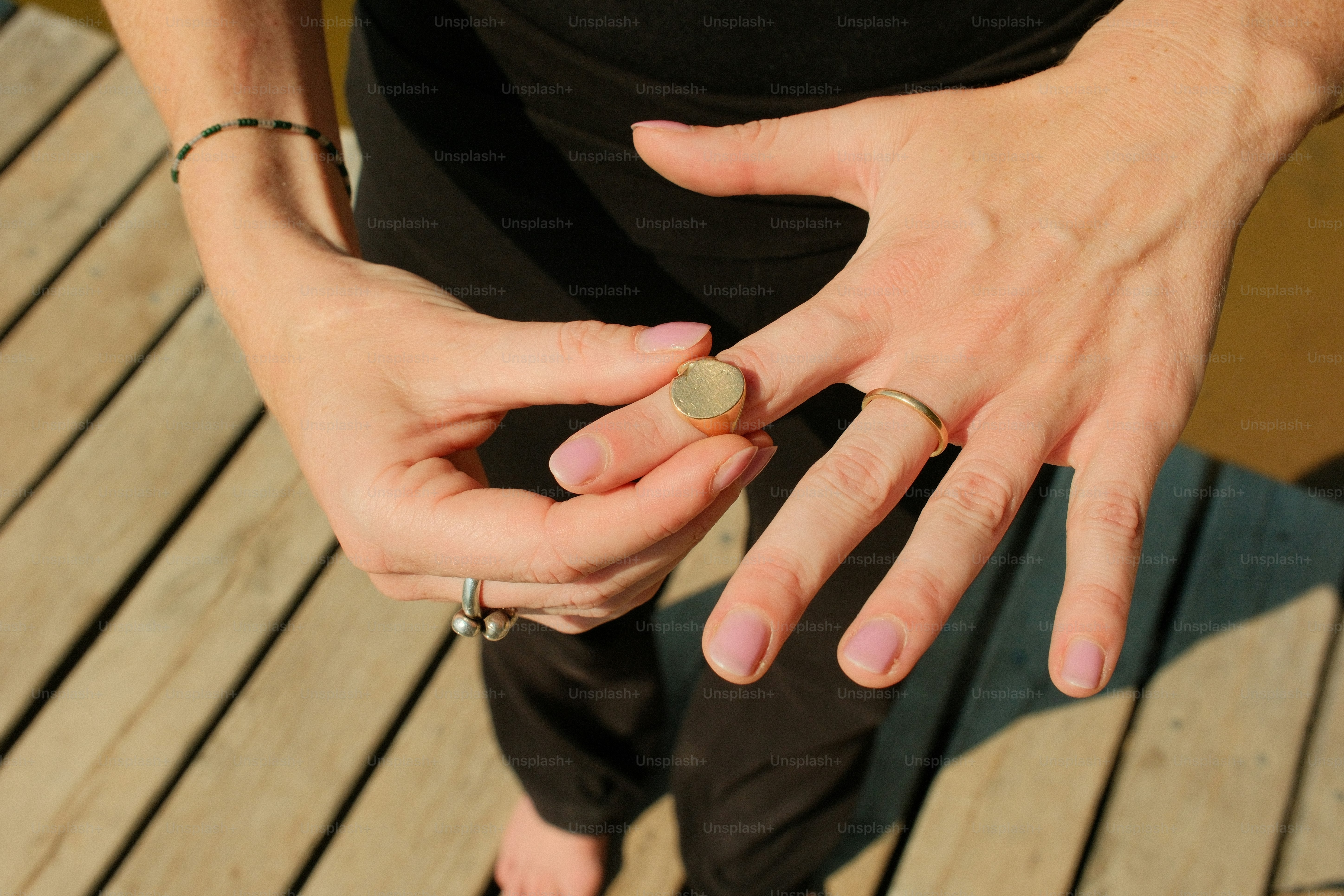 Hands adjusting a bandage on a finger