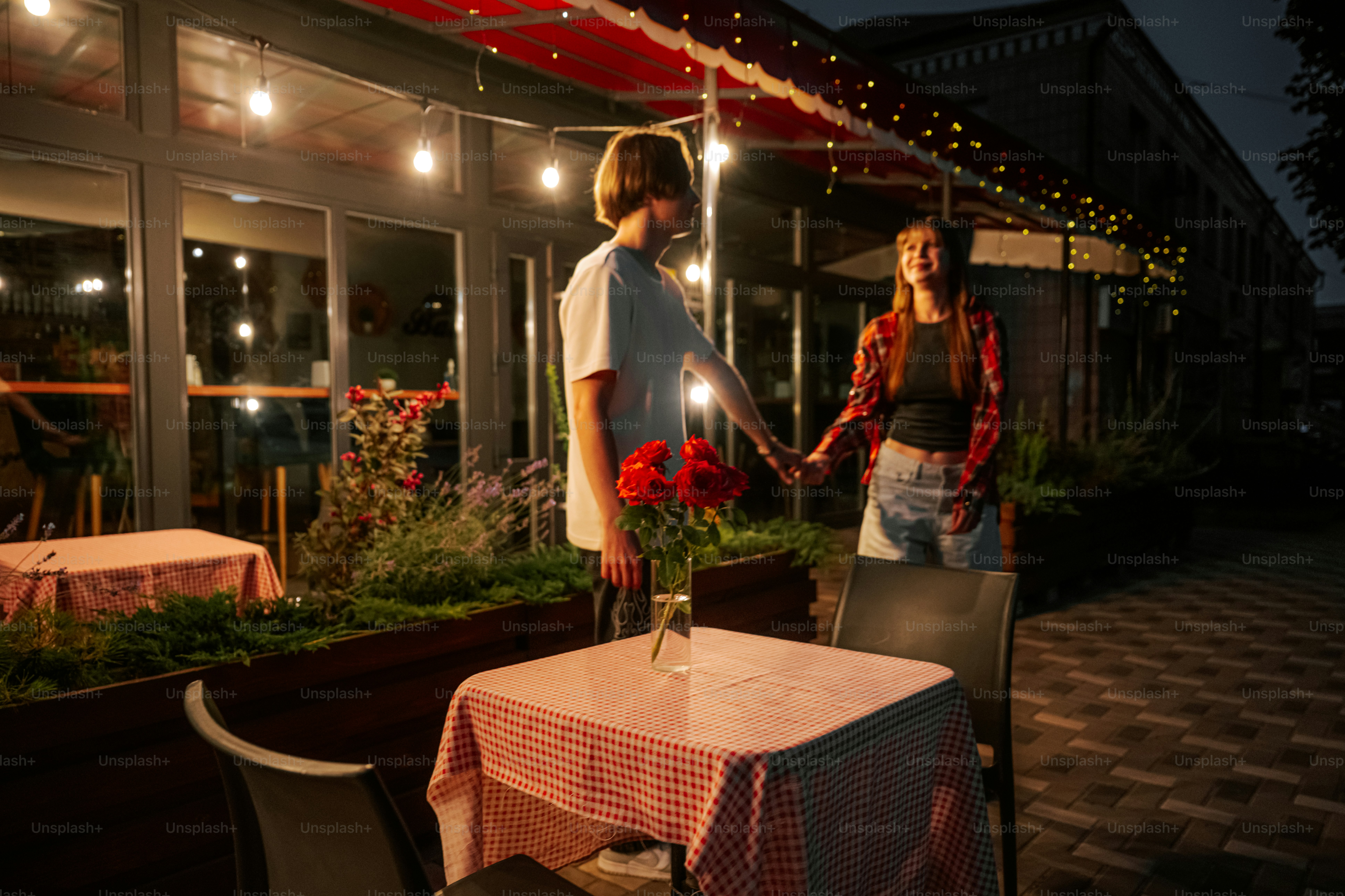 Couple holding hands at outdoor restaurant patio