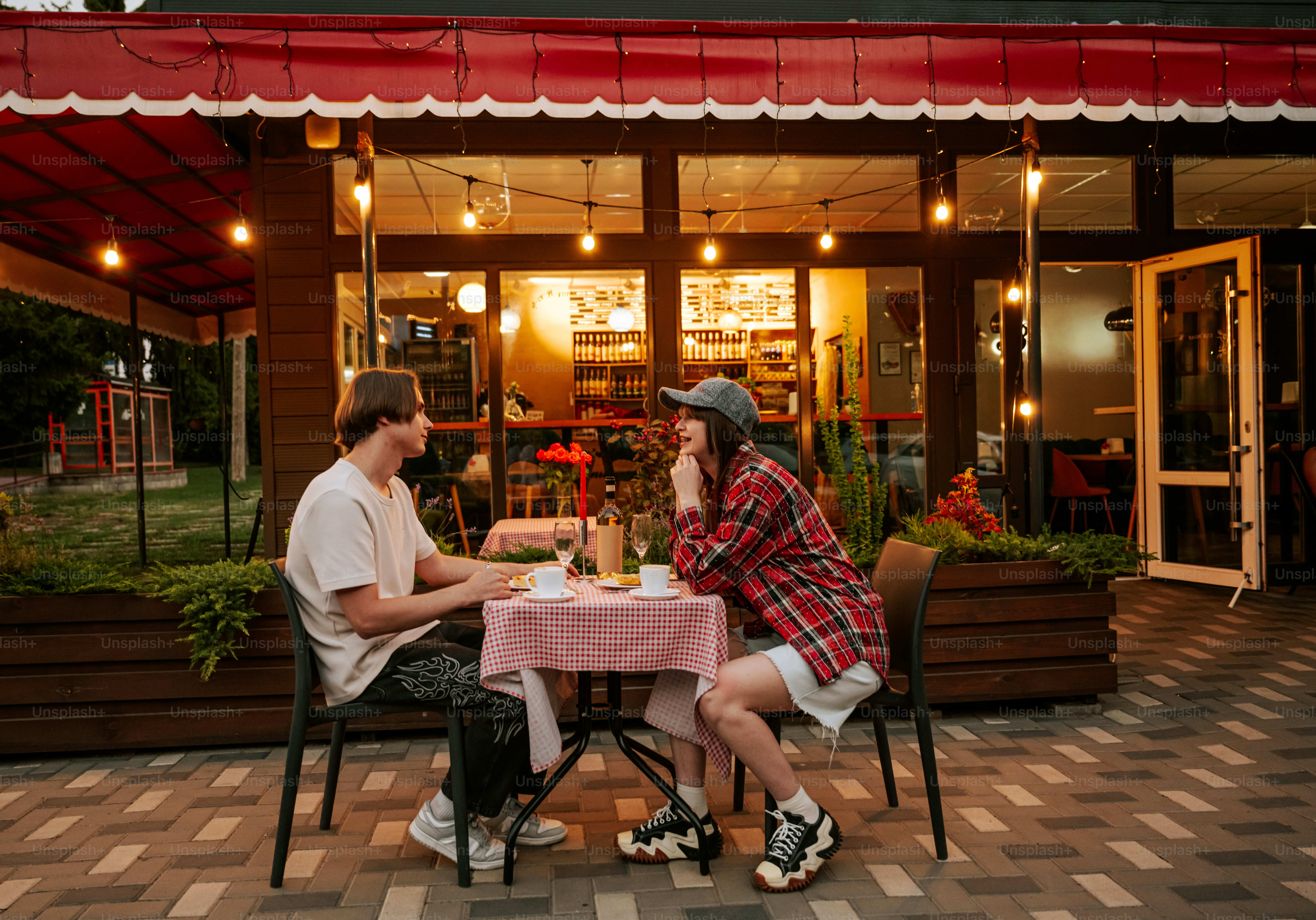 Two people talking at an outdoor cafe