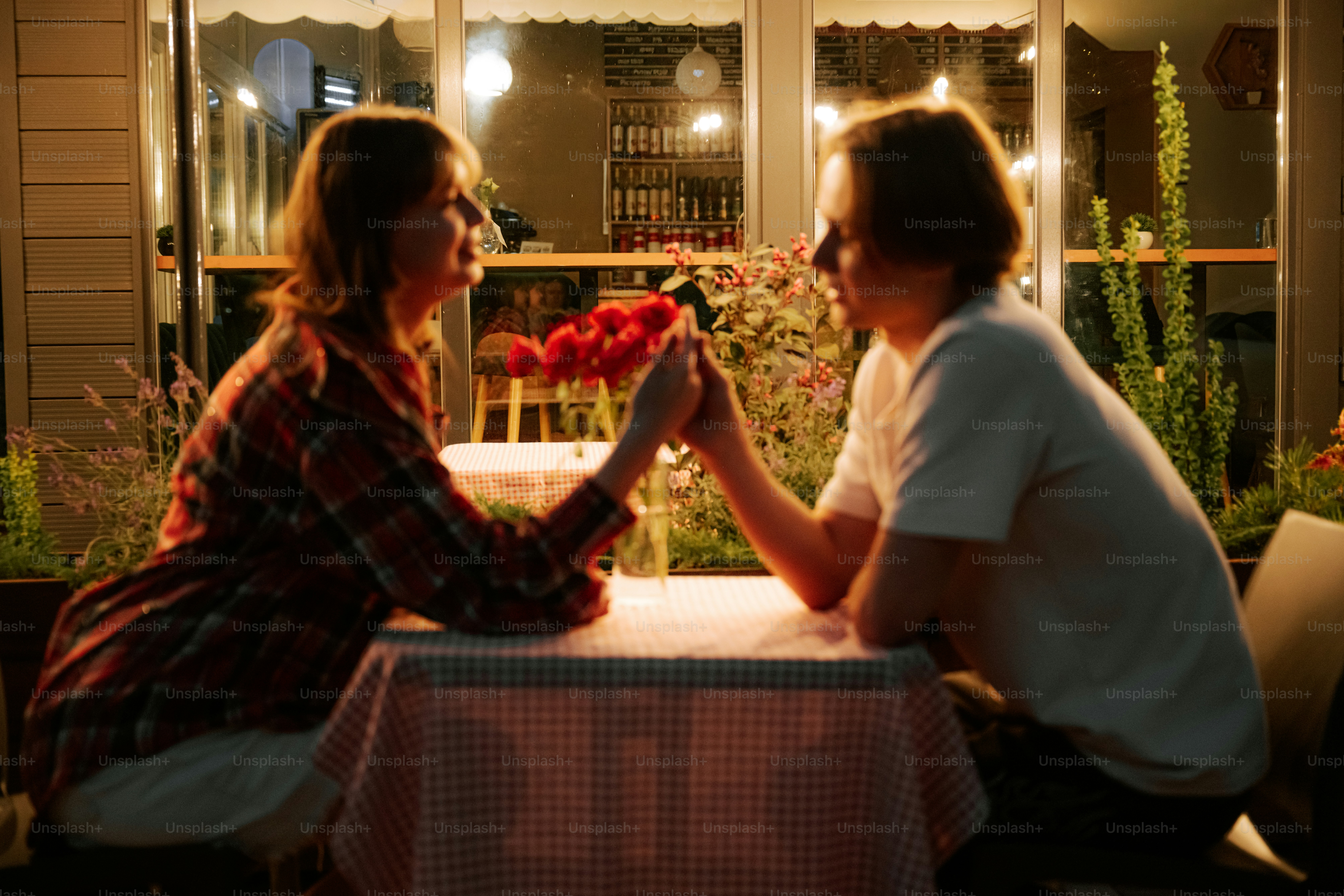 Couple holding hands at outdoor cafe table