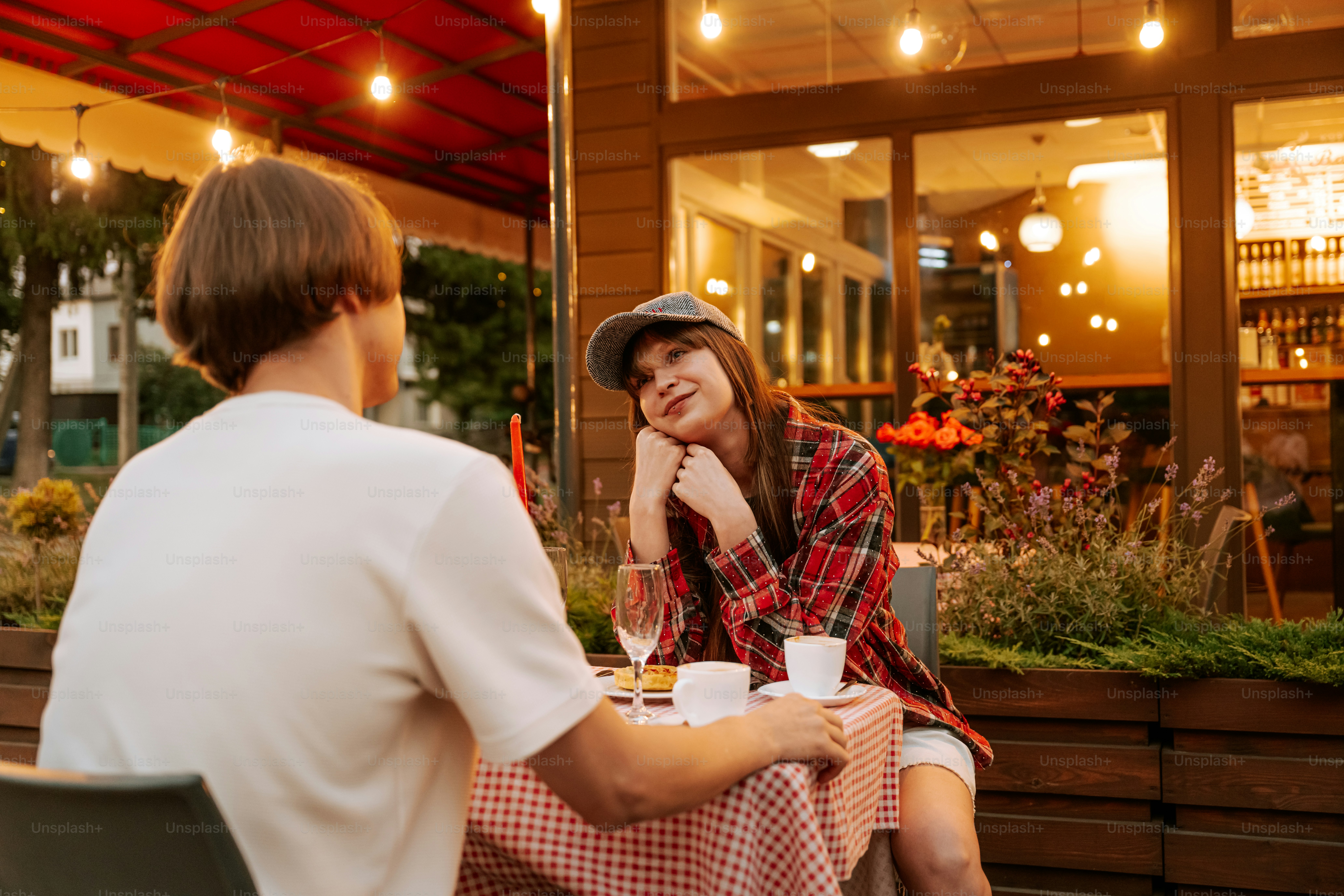 Young couple enjoying outdoor dinner at a cafe