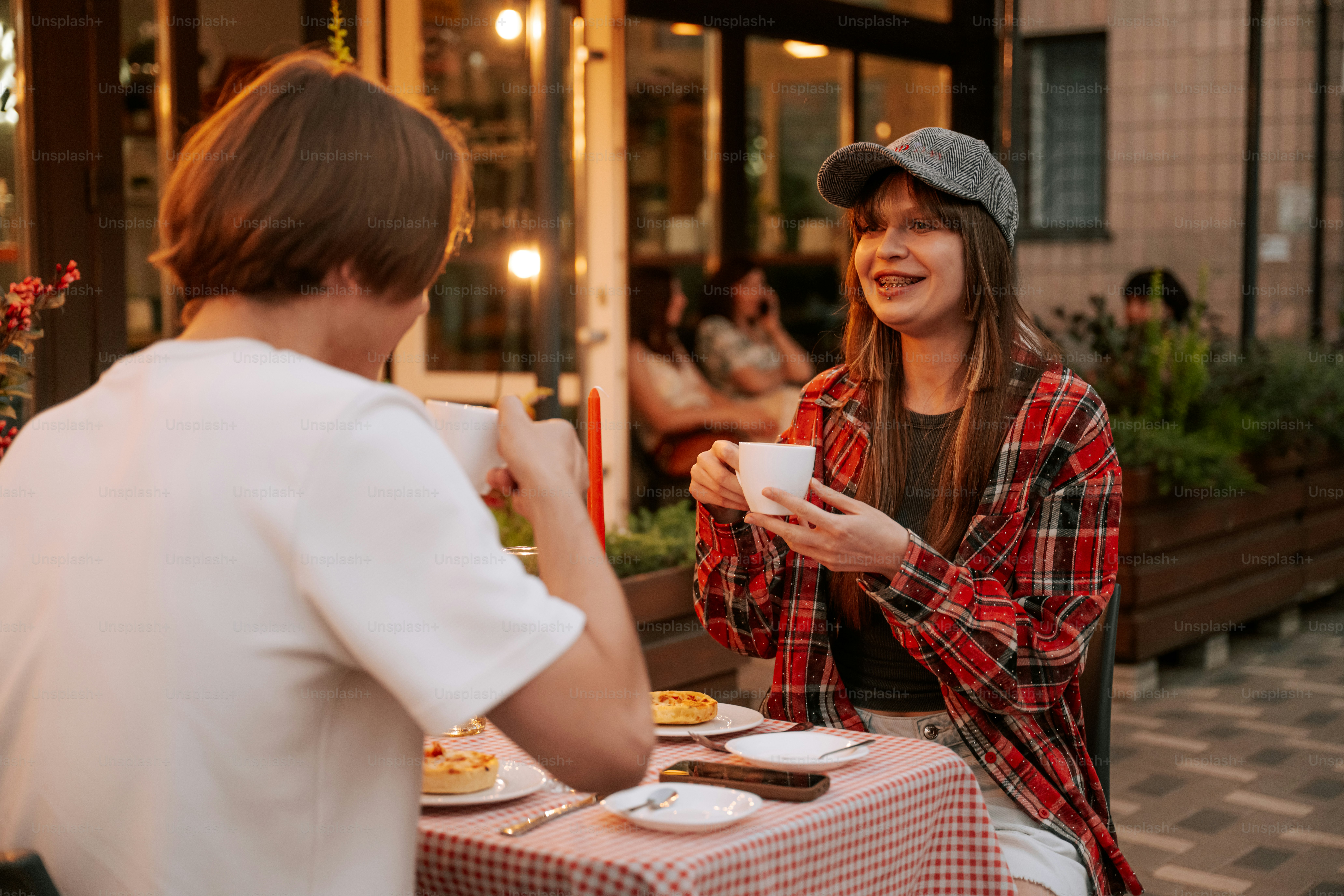 Couple having coffee and pastries at outdoor cafe
