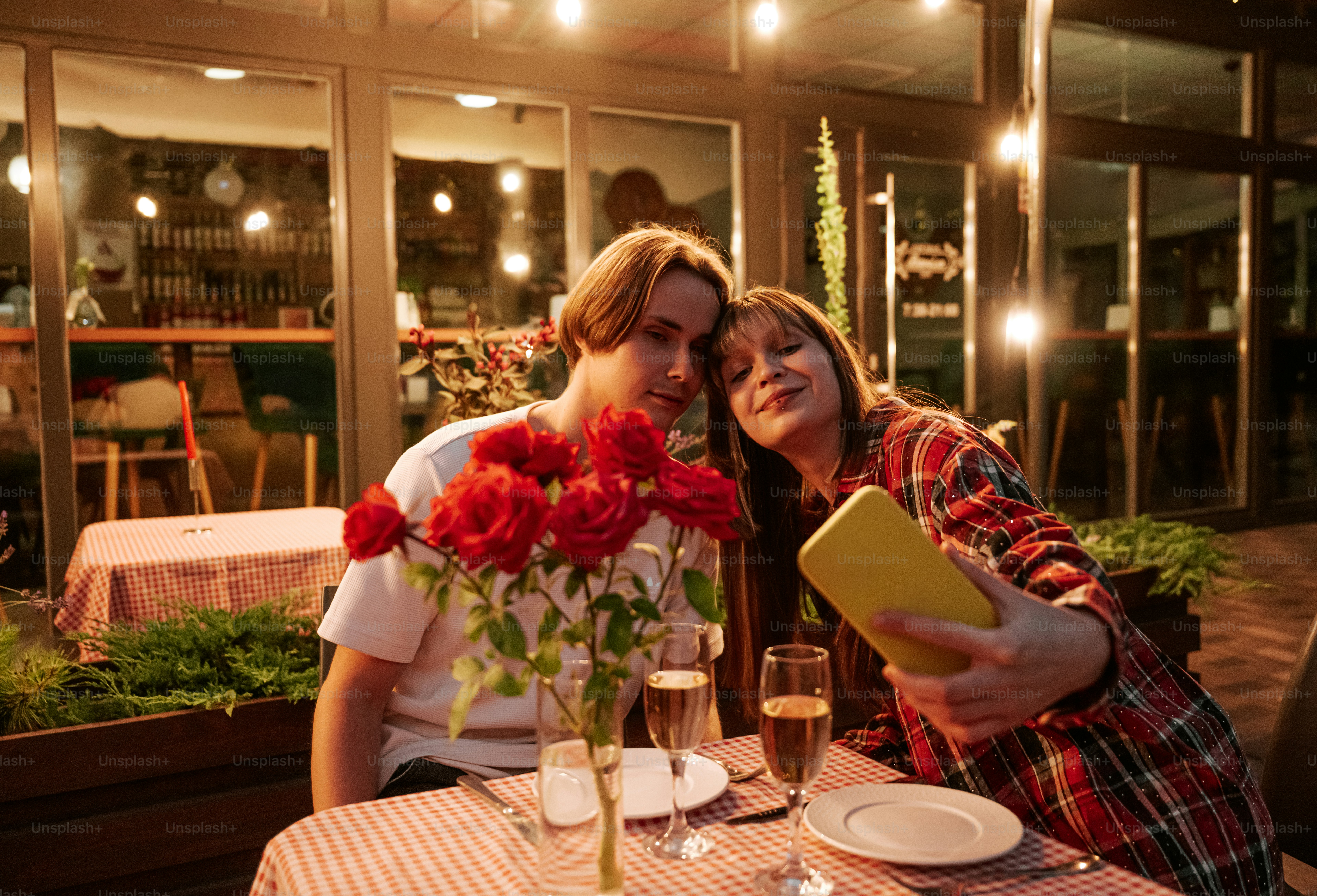 Couple taking a selfie at an outdoor restaurant