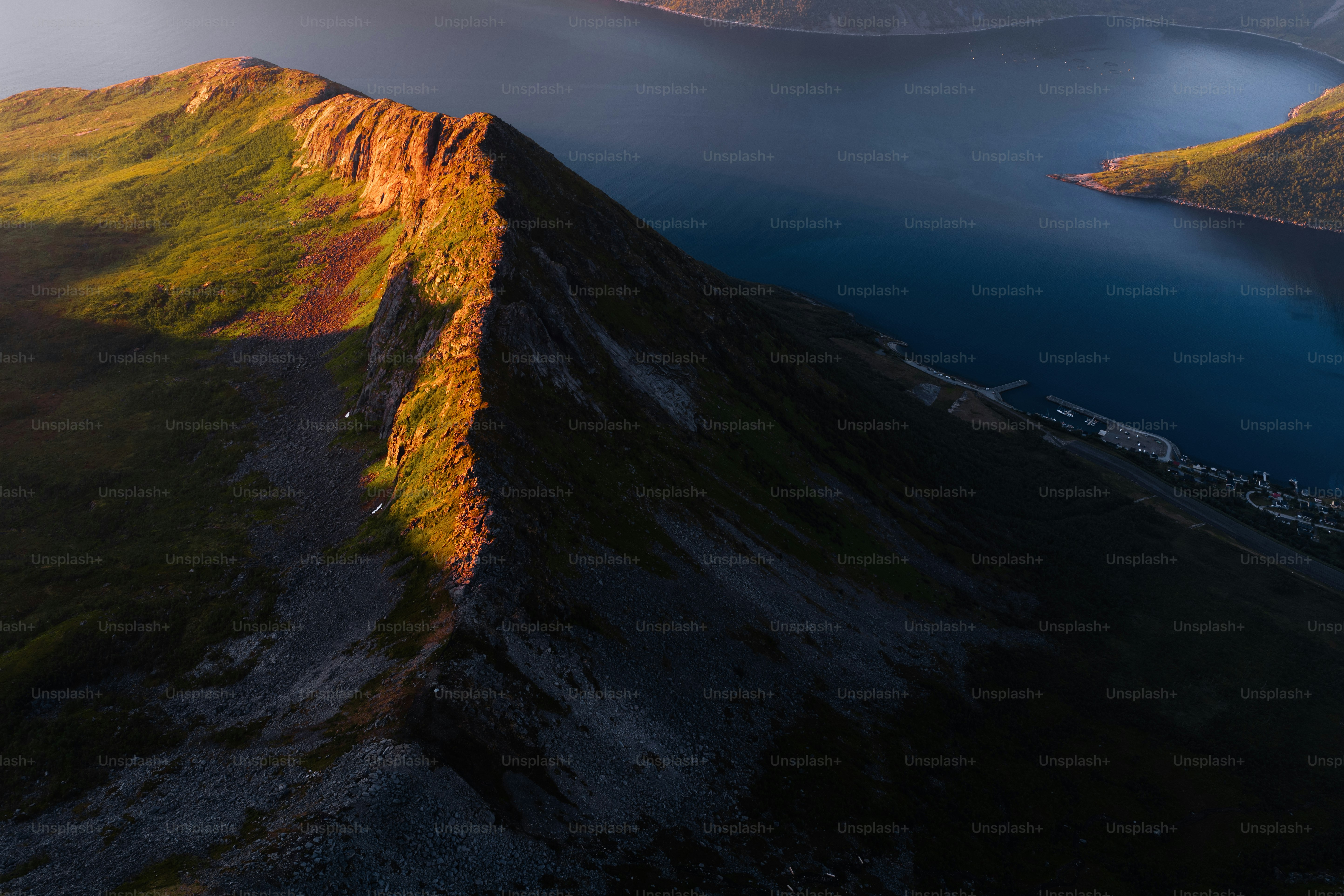 Sunlit mountain ridge overlooking a deep blue lake