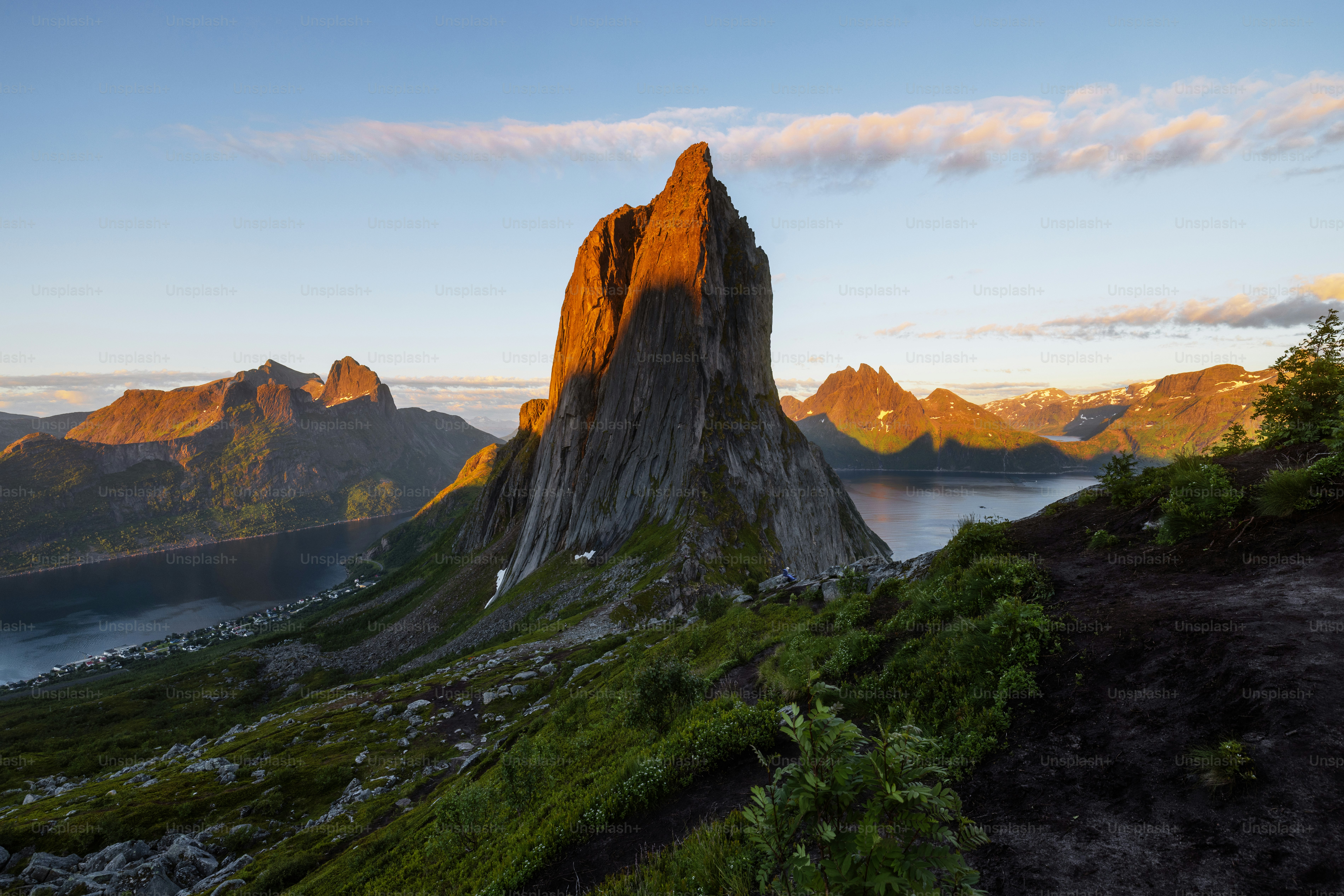 Dramatic mountain peak with golden light over fjord
