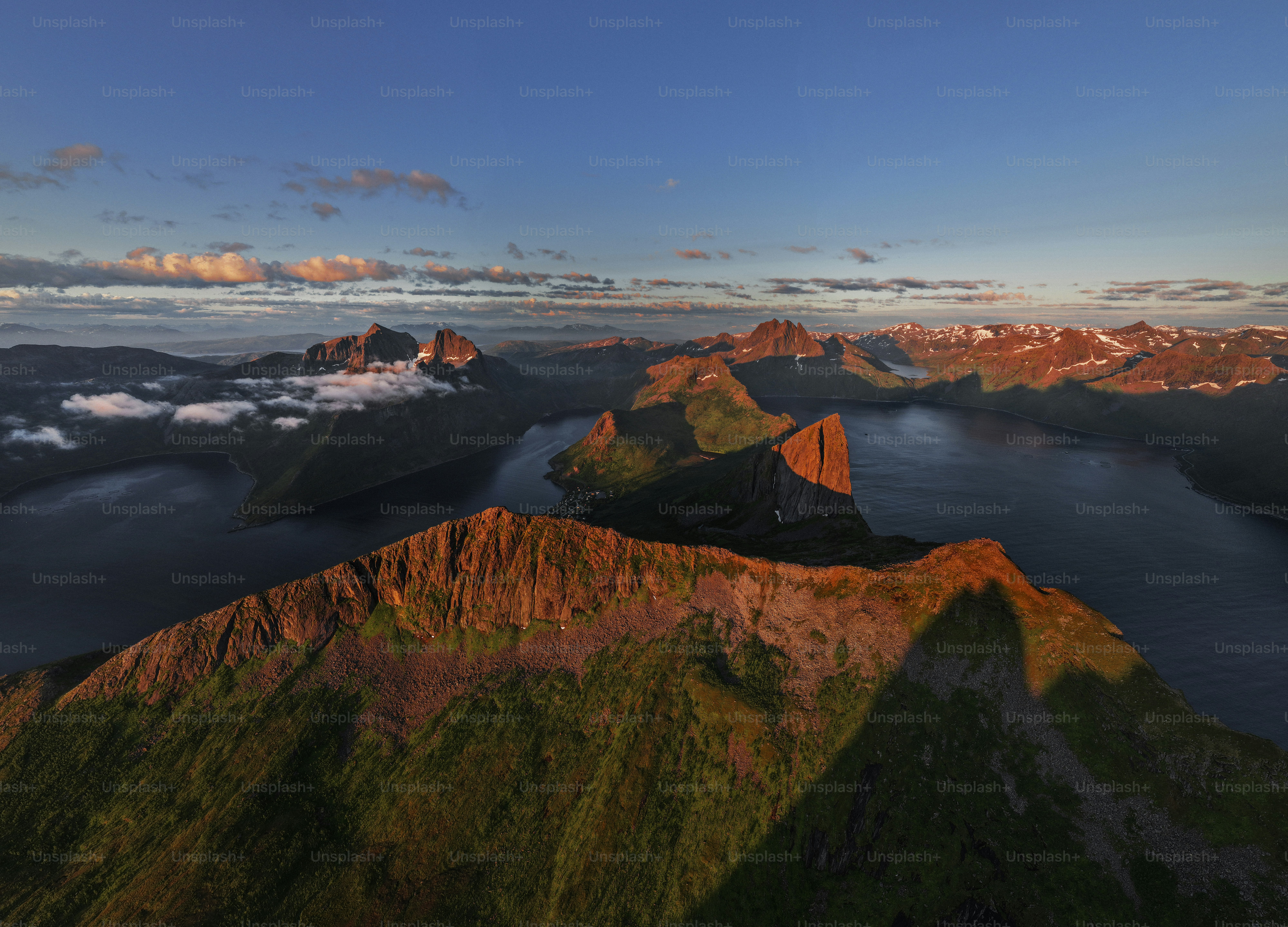 Mountain peaks with golden light overlooking a fjord