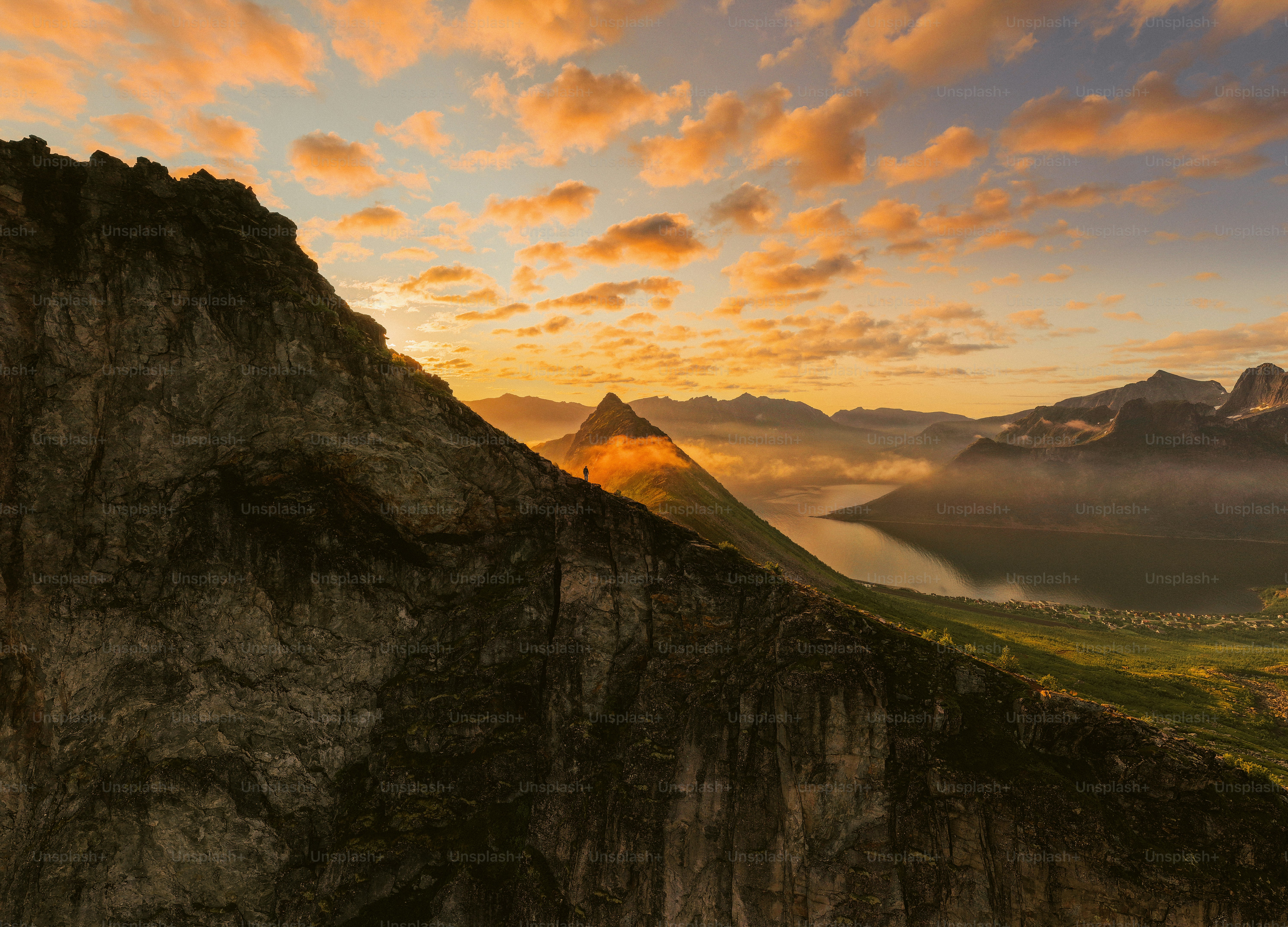 Sunset over a fjord framed by rugged mountains