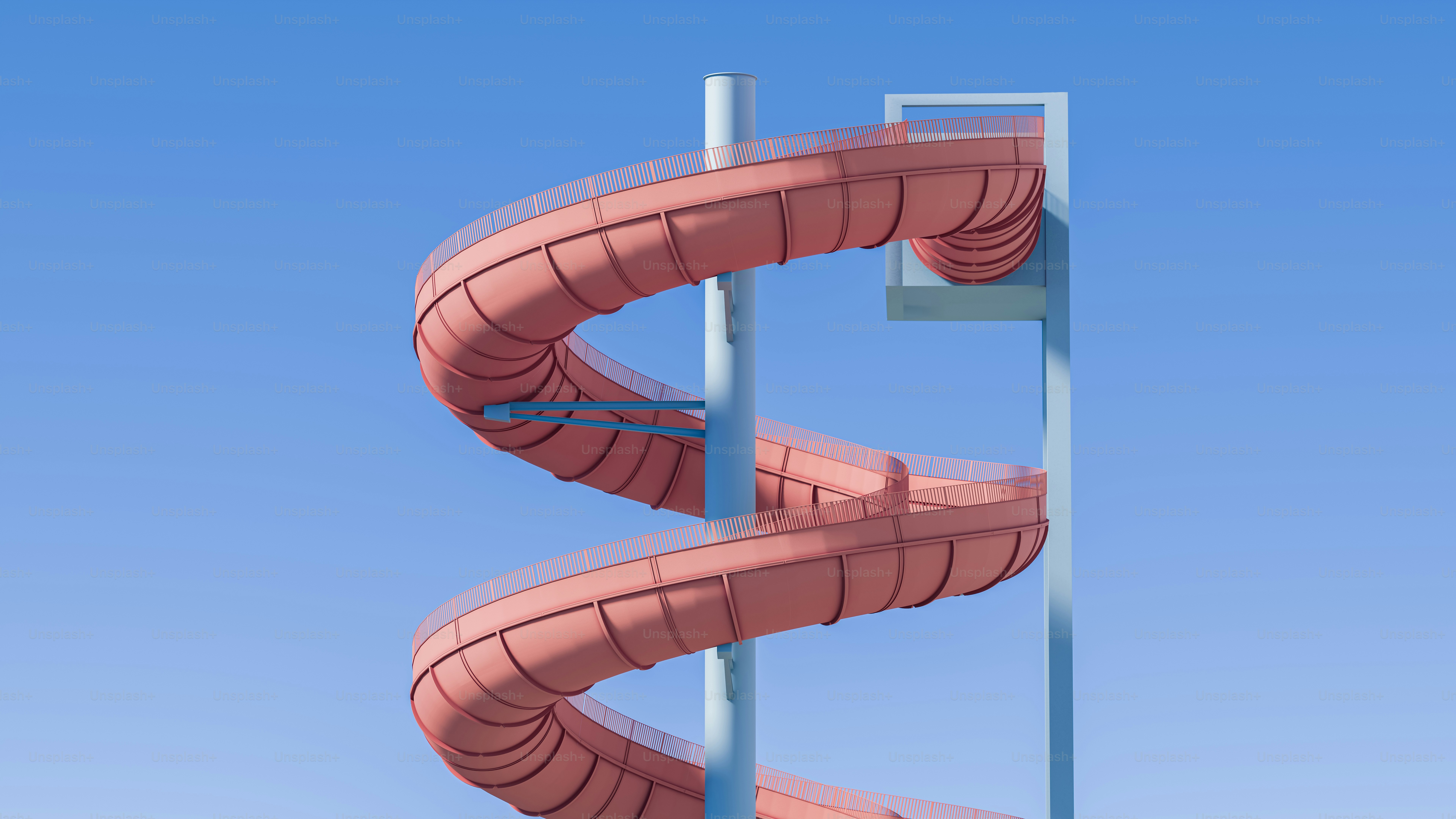 Orange spiral water slide against blue sky