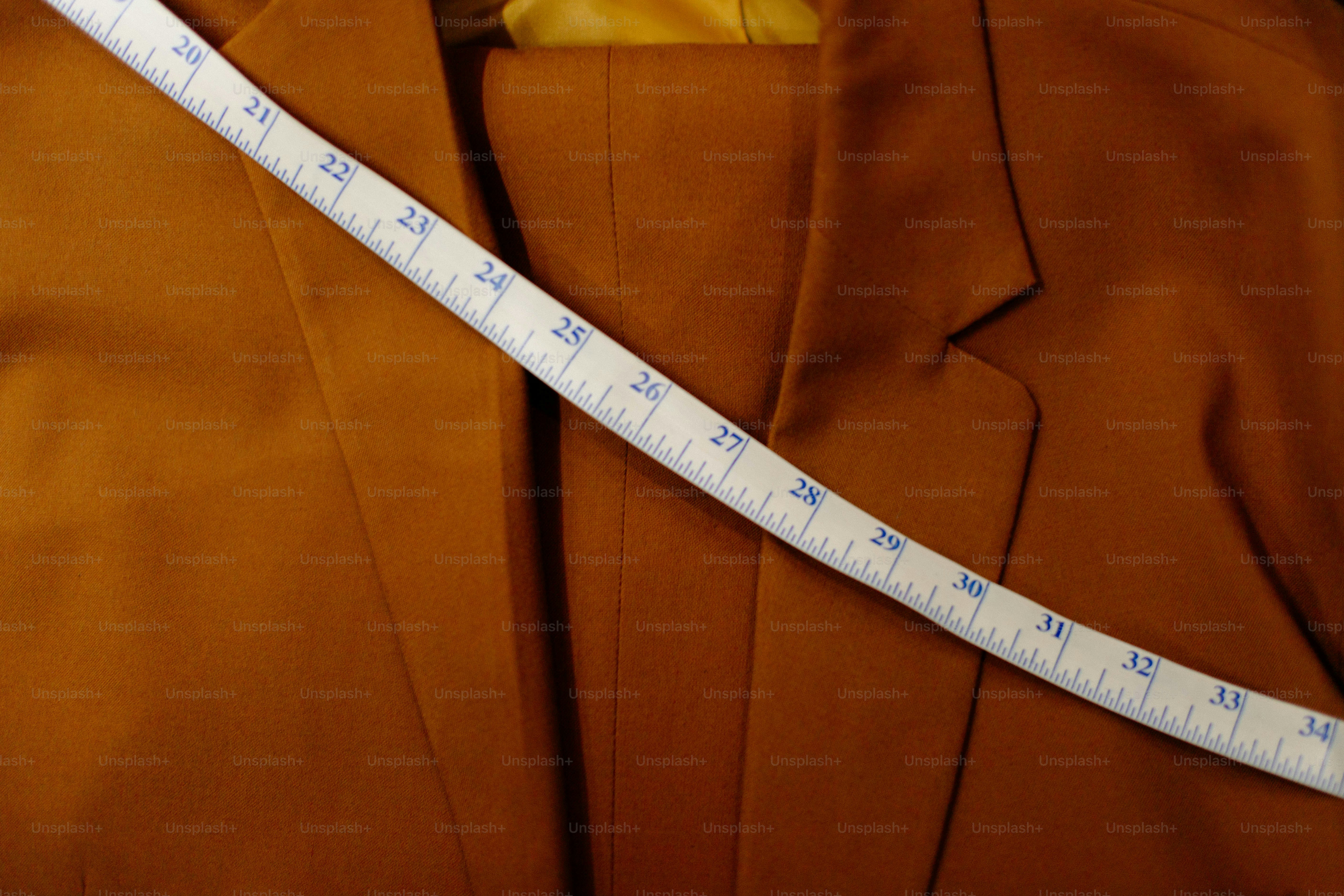 Measuring tape across a brown suit jacket