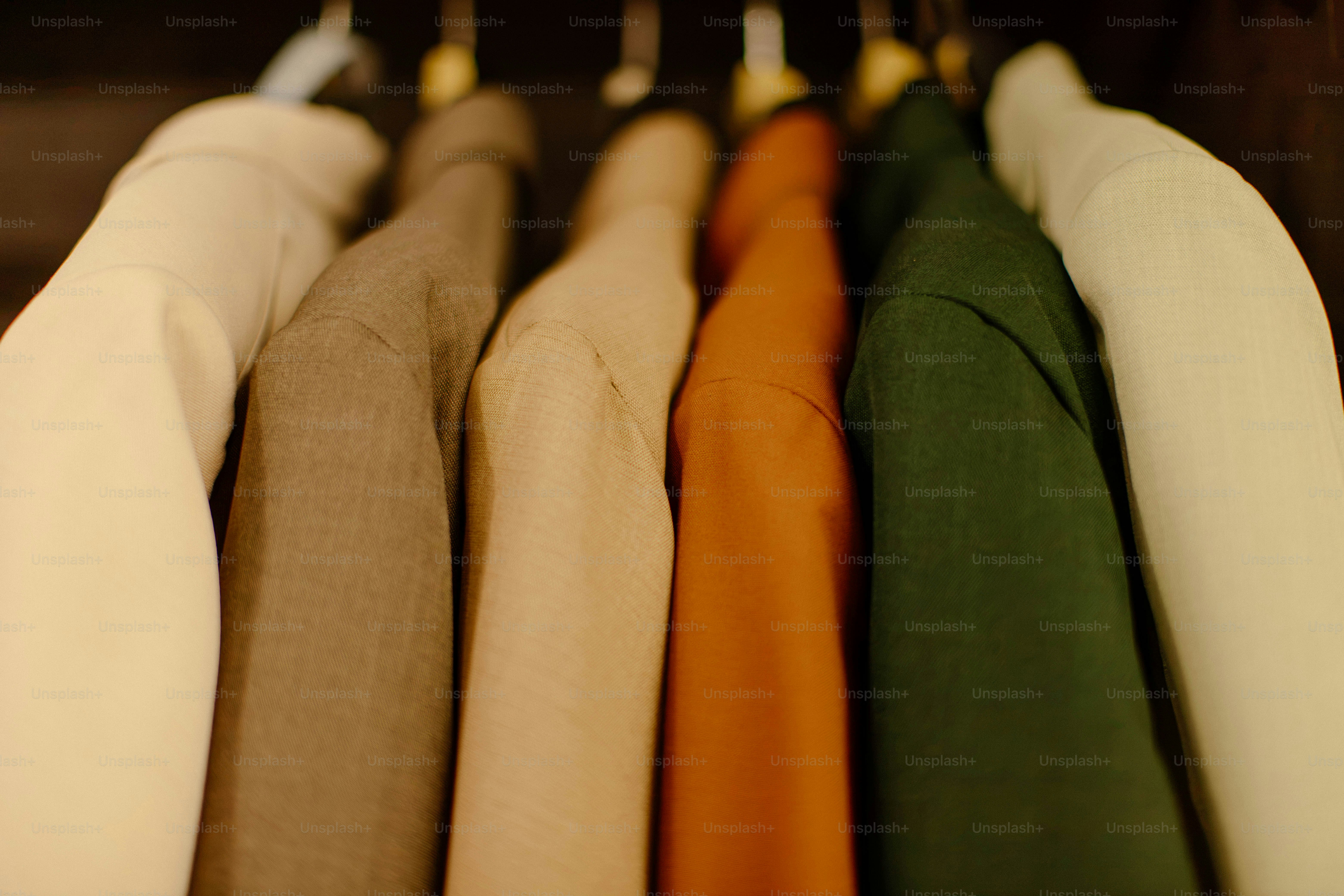 Colorful shirts hanging neatly in a closet