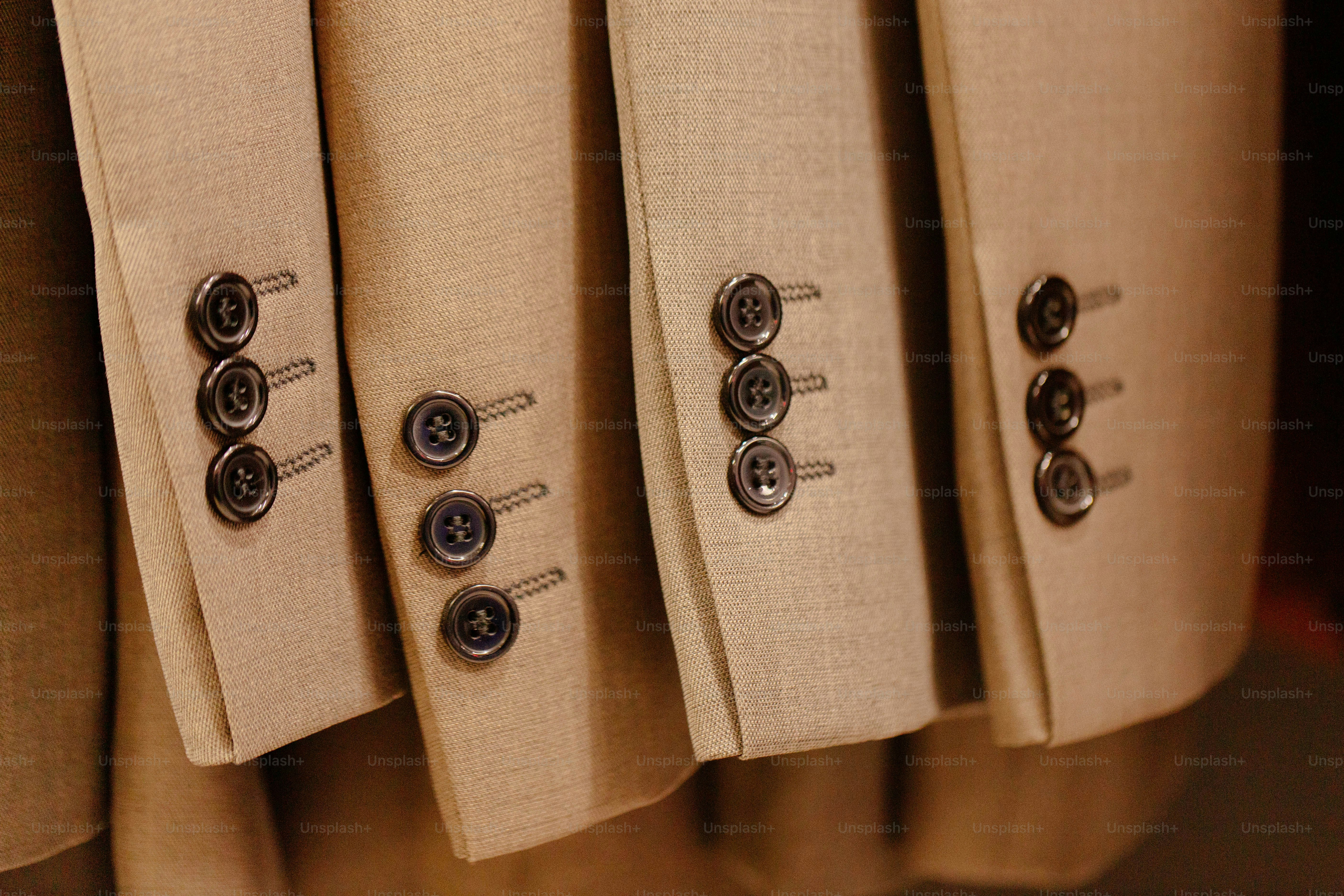 Tan suit sleeves displaying cuff buttons